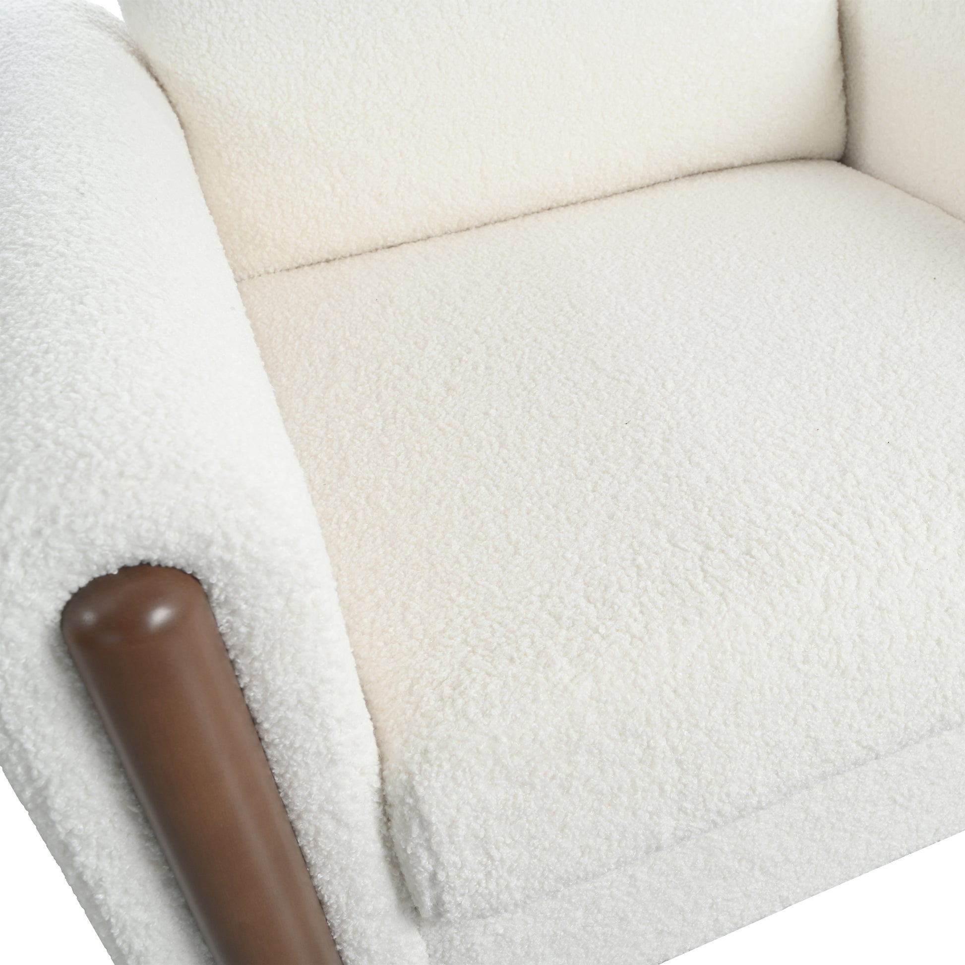 Cream boucle armchair featuring a rich brown wooden armrest accent for modern comfort