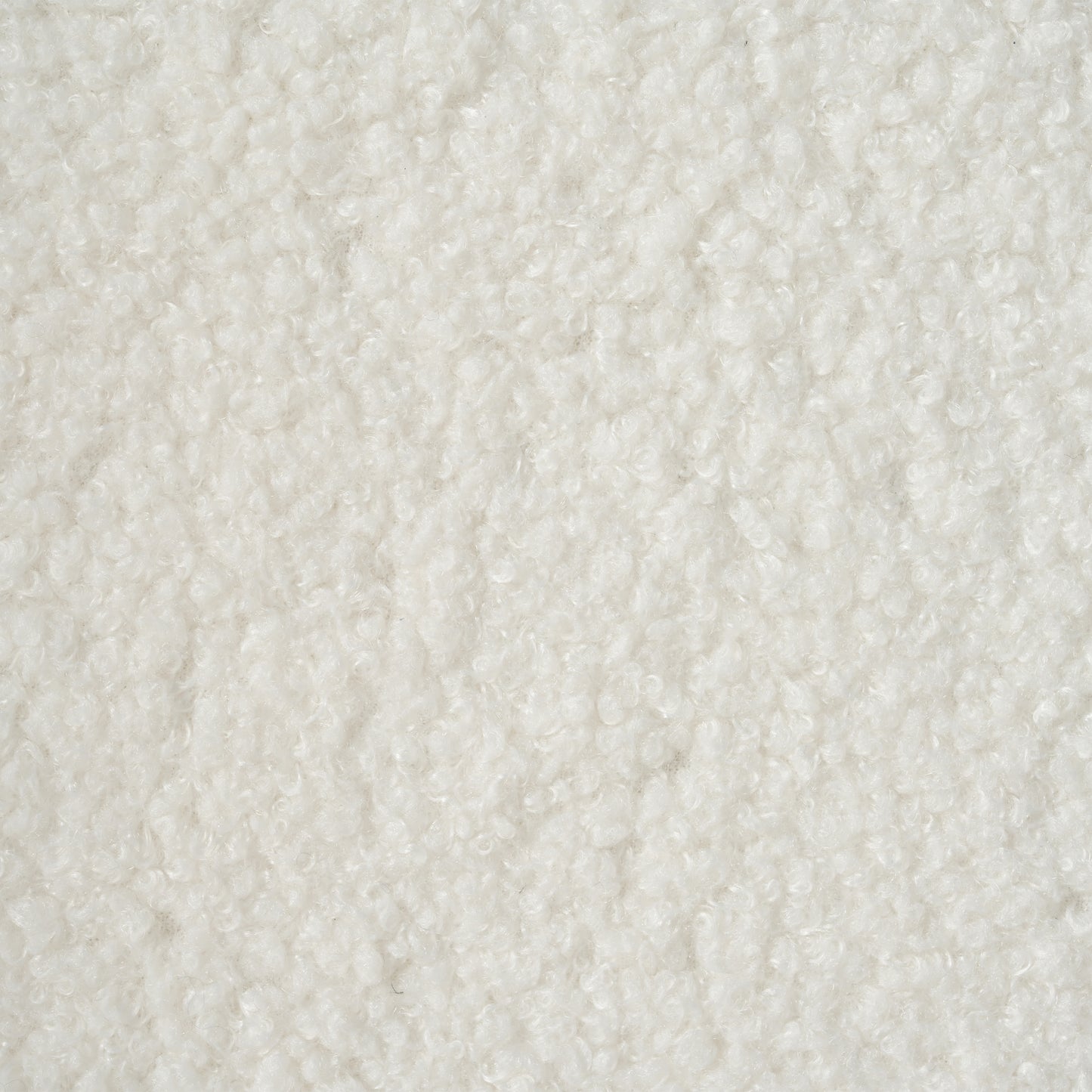 Closeup view of a textured white sherpa fabric ideal for cozy winter apparel