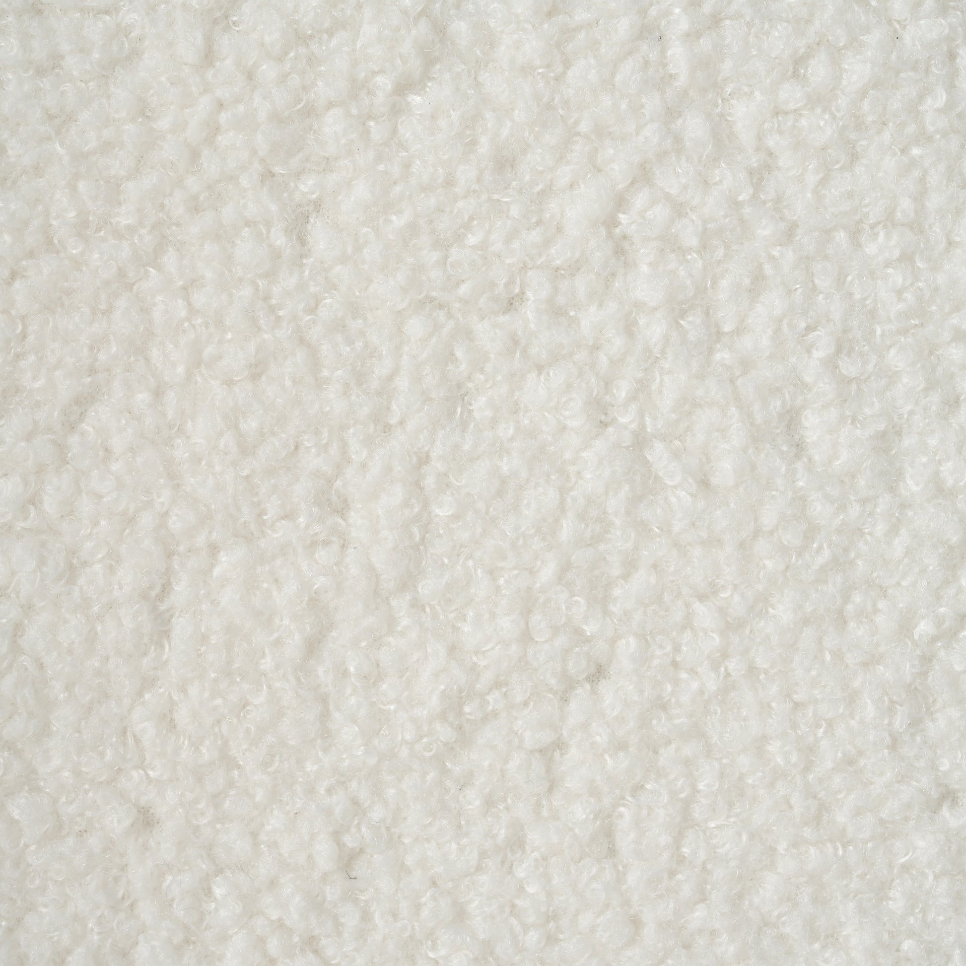 Closeup view of a textured white sherpa fabric ideal for cozy winter apparel