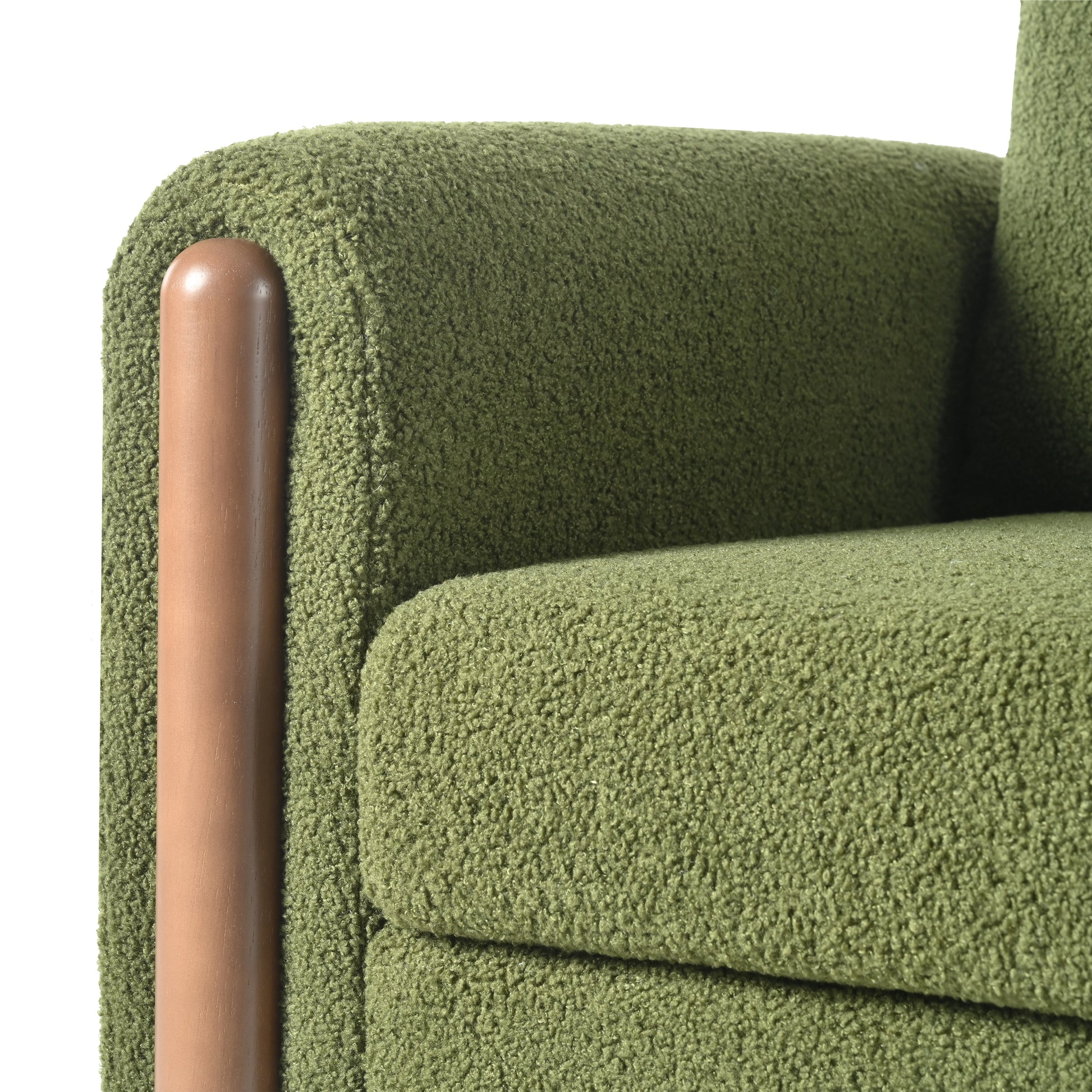 Green teddy fabric armchair detail with rounded wooden armrest accent
