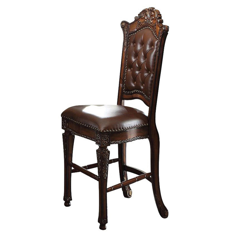 Ornate brown leather tufted bar stool with carved wood details and brass nailhead trim