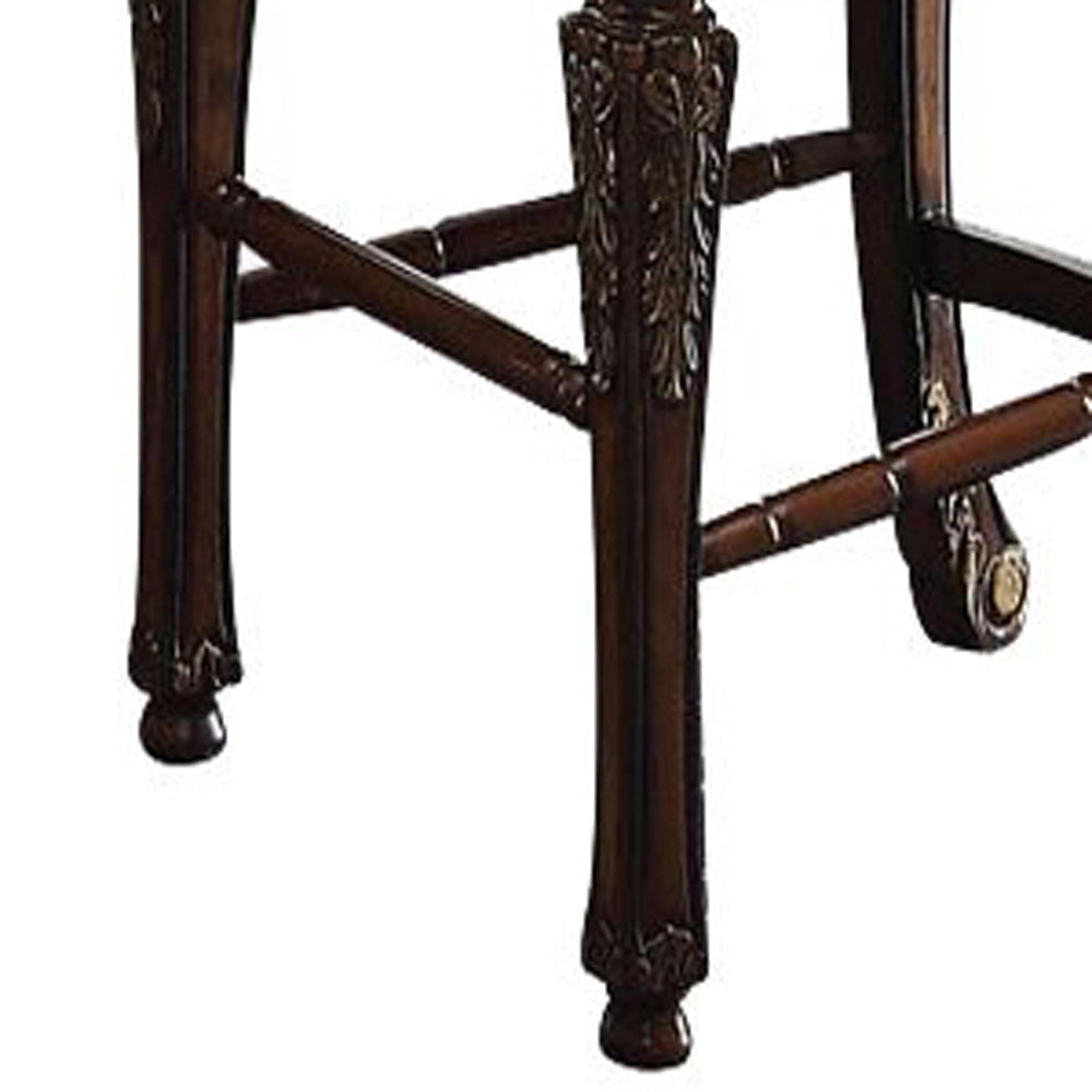 Ornate dark wood carved leg detail on a classic bar stool base