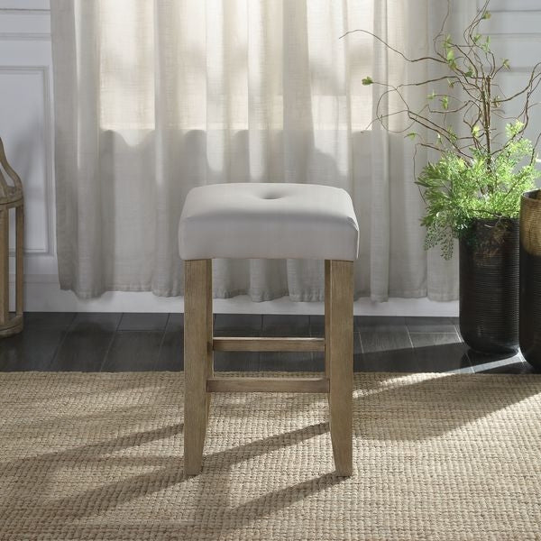Light grey upholstered bar stool with tufted seat and natural wood legs