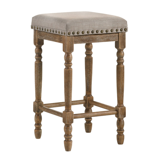 Rustic grey linen bar stool with antique brass nailhead trim and turned wood legs