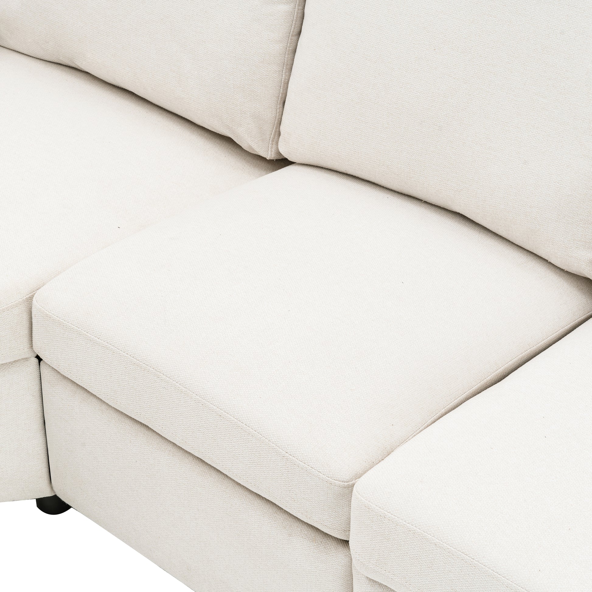Closeup of a textured cream fabric sofa seat and back cushions showing plush comfort