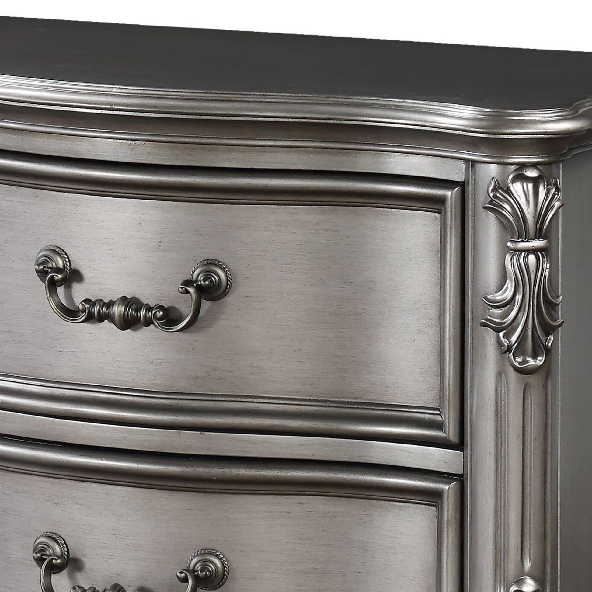 Elegant gray dresser with ornate drawer pulls and carved detailing perfect for a classic bedroom