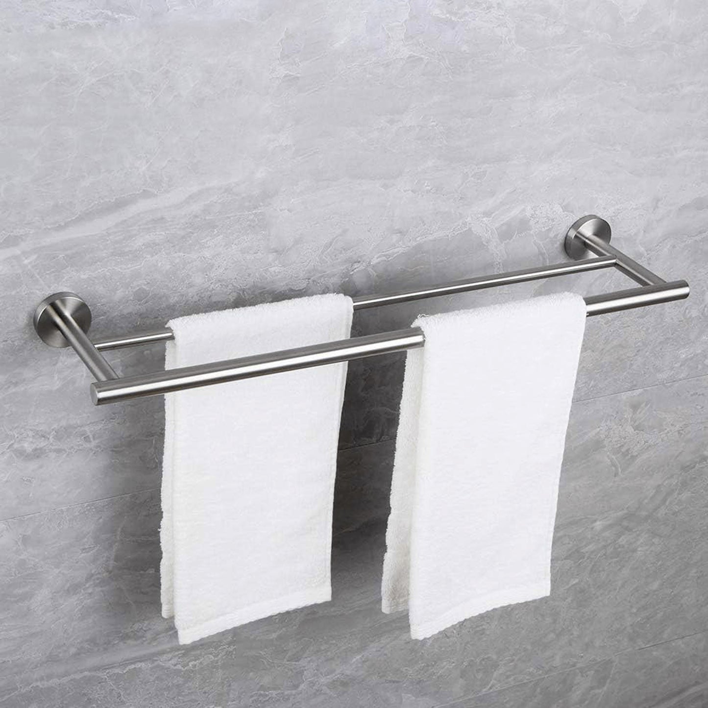 Brushed nickel double towel bar holding two white bath towels securely
