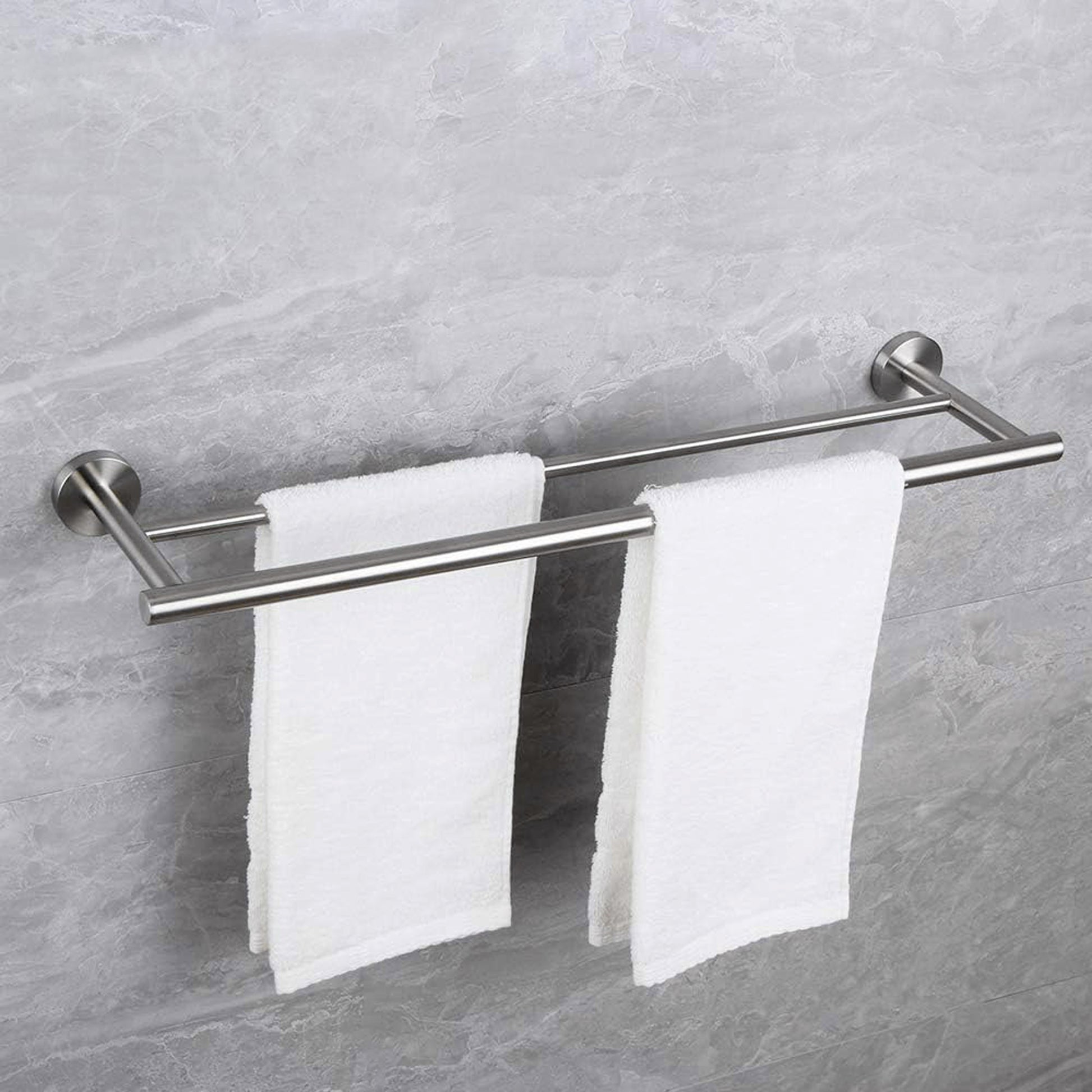 Brushed nickel double towel bar holding two white bath towels securely