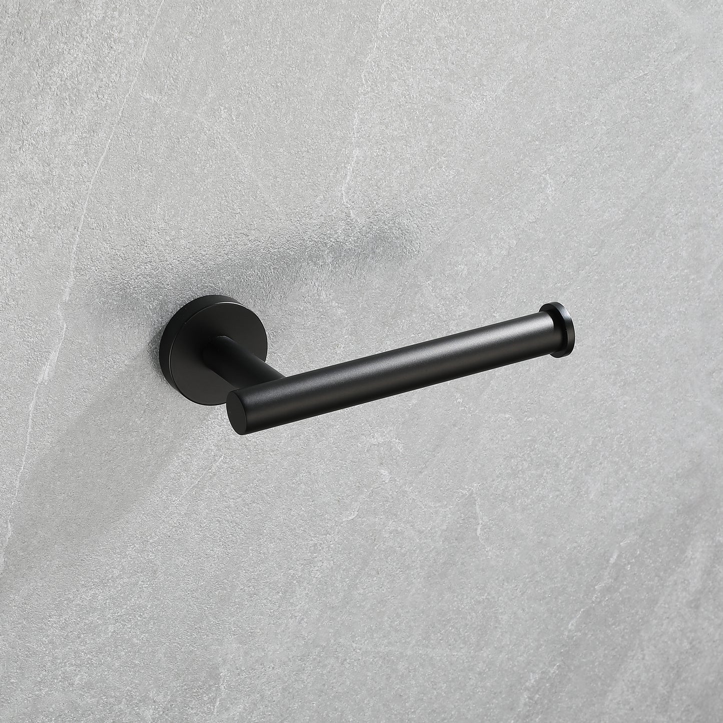 Modern black toilet paper holder with a sleek minimalist design mounted on a grey textured wall