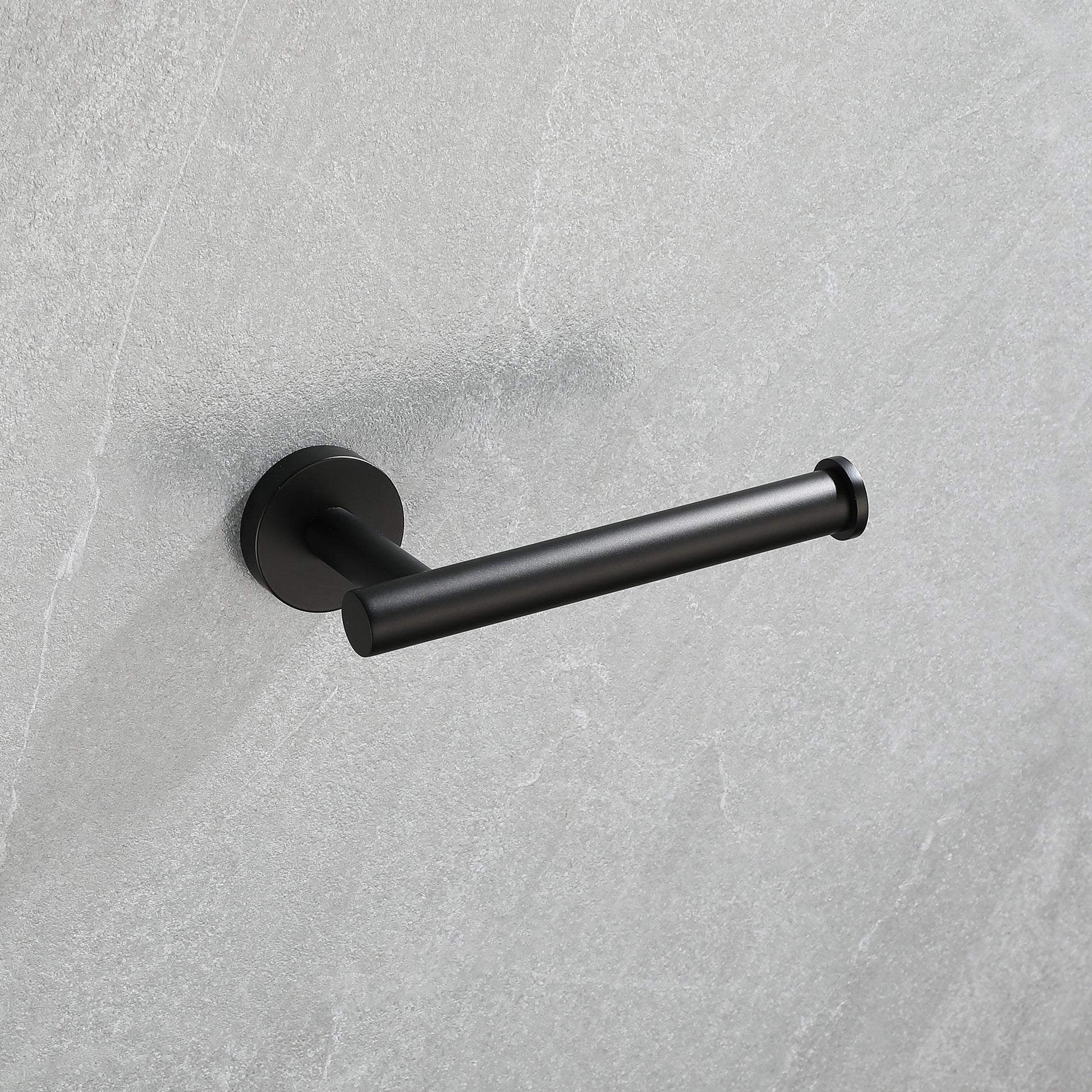 Modern black toilet paper holder with a sleek minimalist design mounted on a grey textured wall
