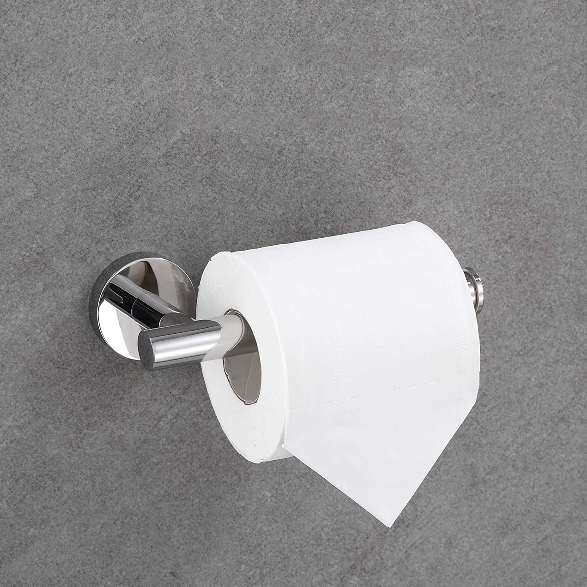 Polished chrome toilet paper holder with a single roll of white paper mounted on a grey textured wall