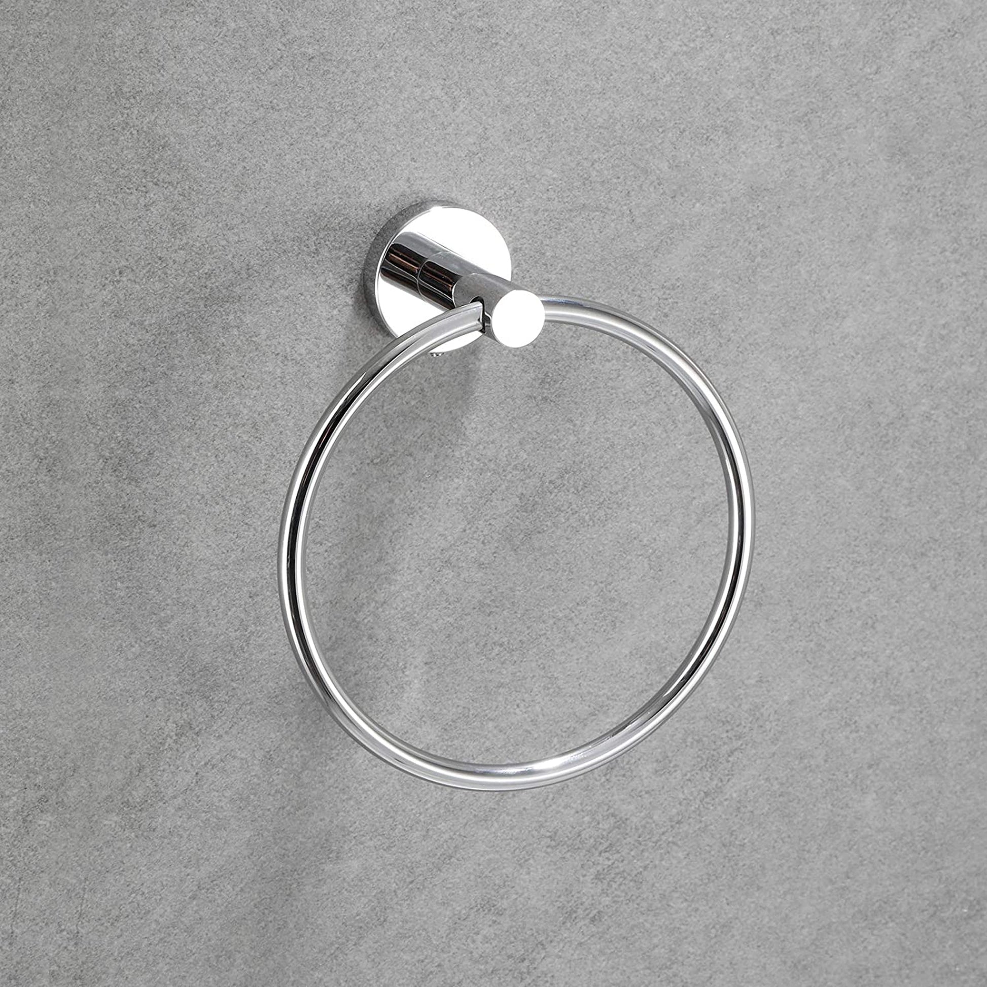 Polished chrome round towel ring mounted on a grey textured wall