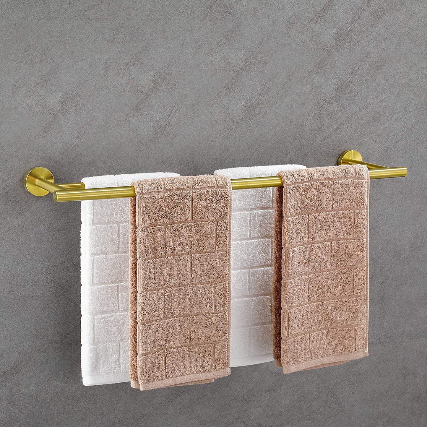 Brushed gold double towel bar holding white and tan textured towels