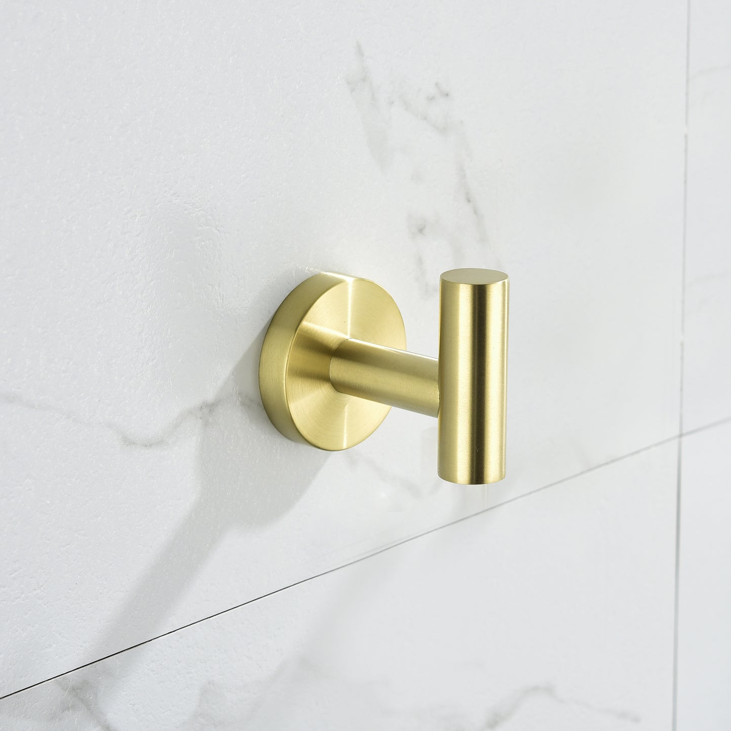 Modern brushed brass wall hook with cylindrical design for bathroom organization