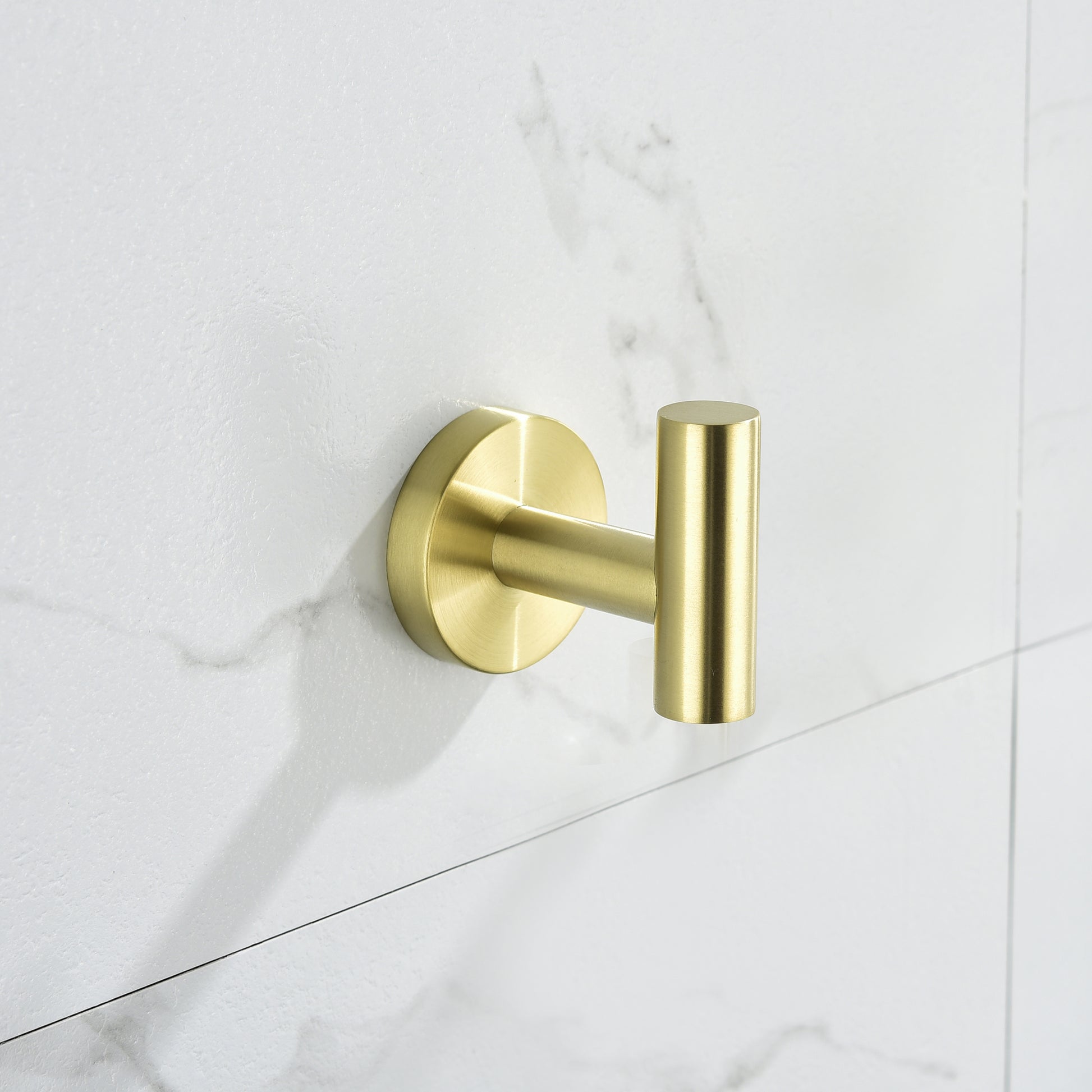 Modern brushed brass wall hook with cylindrical design for bathroom organization