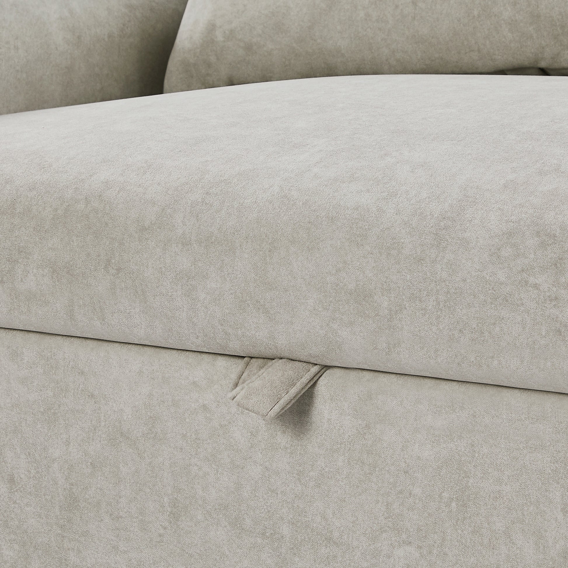 Light grey velvet sofa fabric with visible texture and pull tab