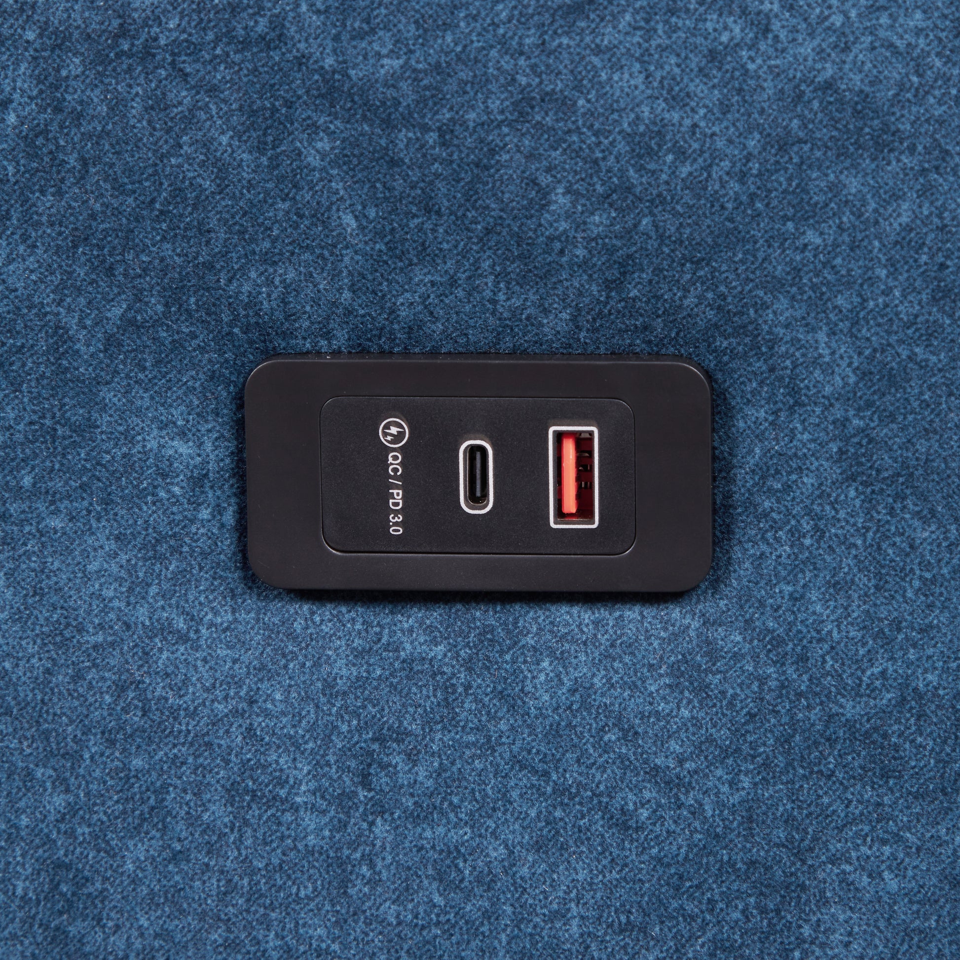 Black USBC PD and Quick Charge  dual port charger integrated into blue textured fabric