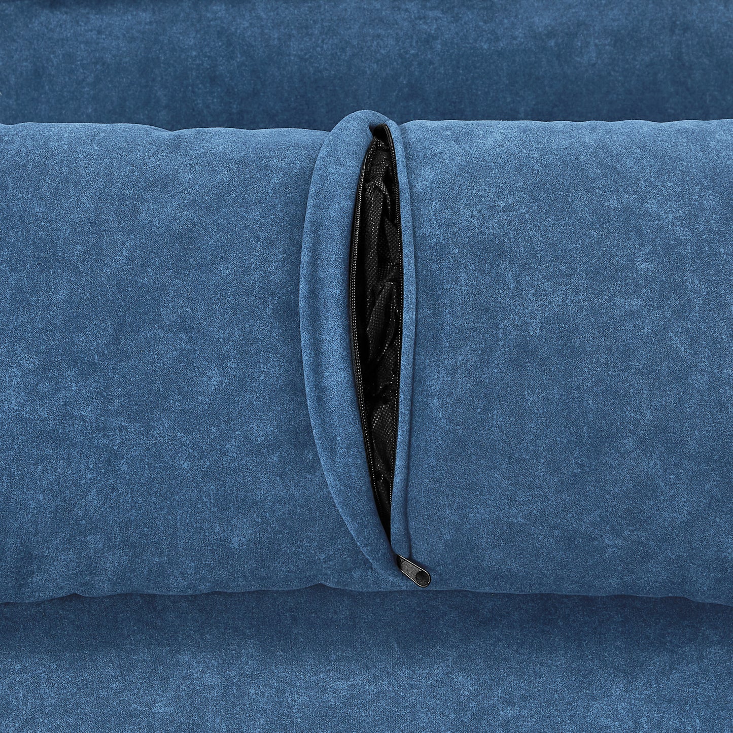 Blue velvet cushion with exposed zipper detail and black fabric backing