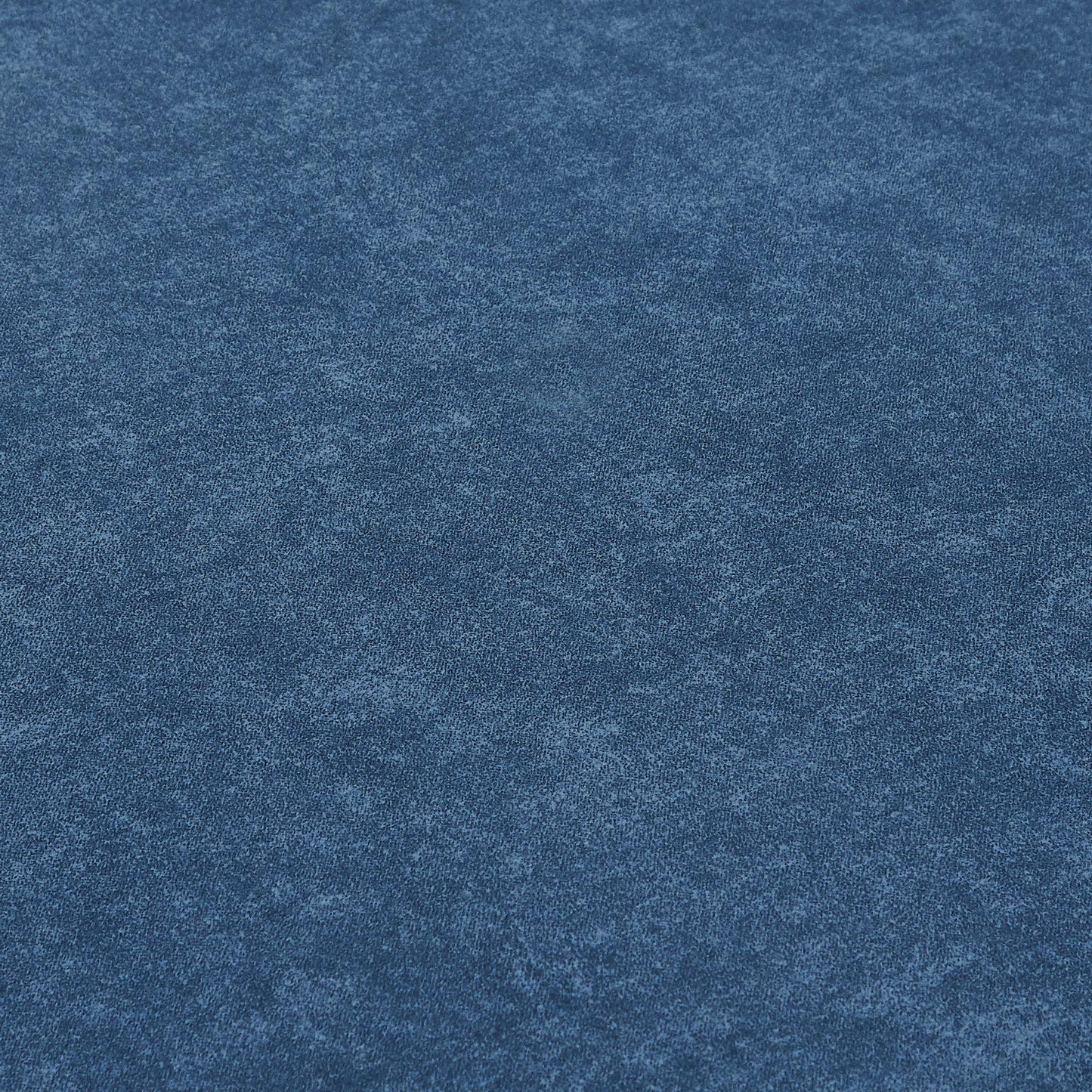 Textured navy blue faux suede fabric closeup