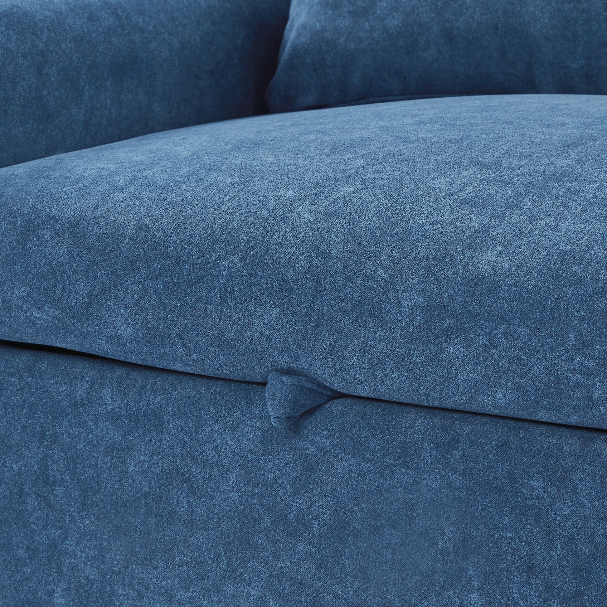 Closeup of textured dark blue velvet upholstery on a modern sofa