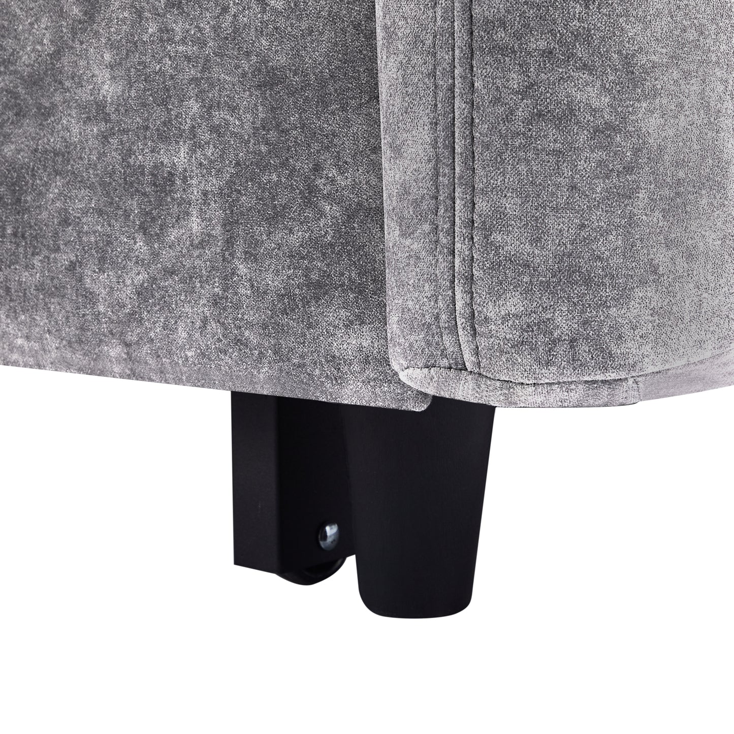 Closeup of distressed grey velvet fabric on a sofa arm showcasing its texture and stitching