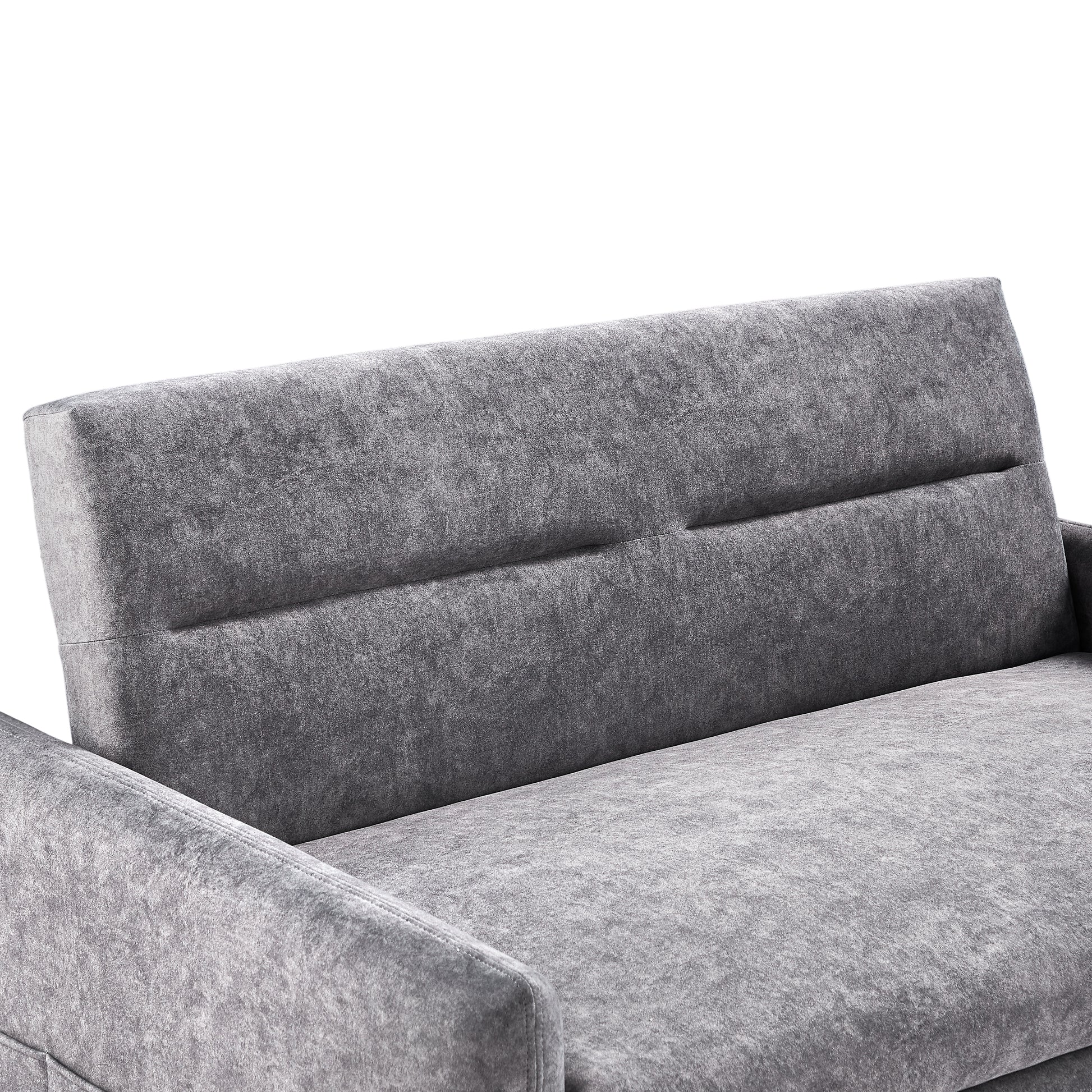 Closeup of a plush grey velvet sofa showcasing its textured fabric and modern stitching