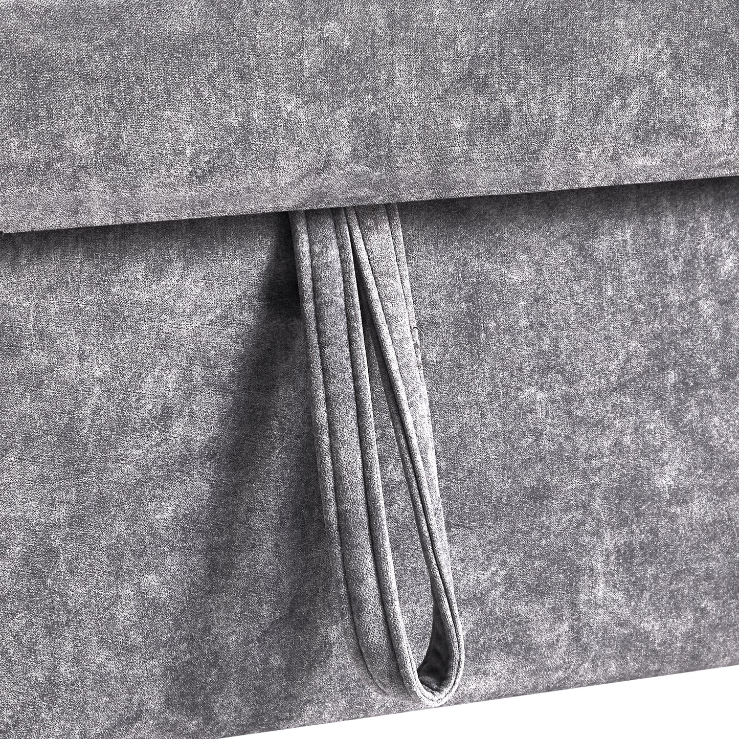 Closeup of textured grey fabric with a folded loop detail for storage boxes