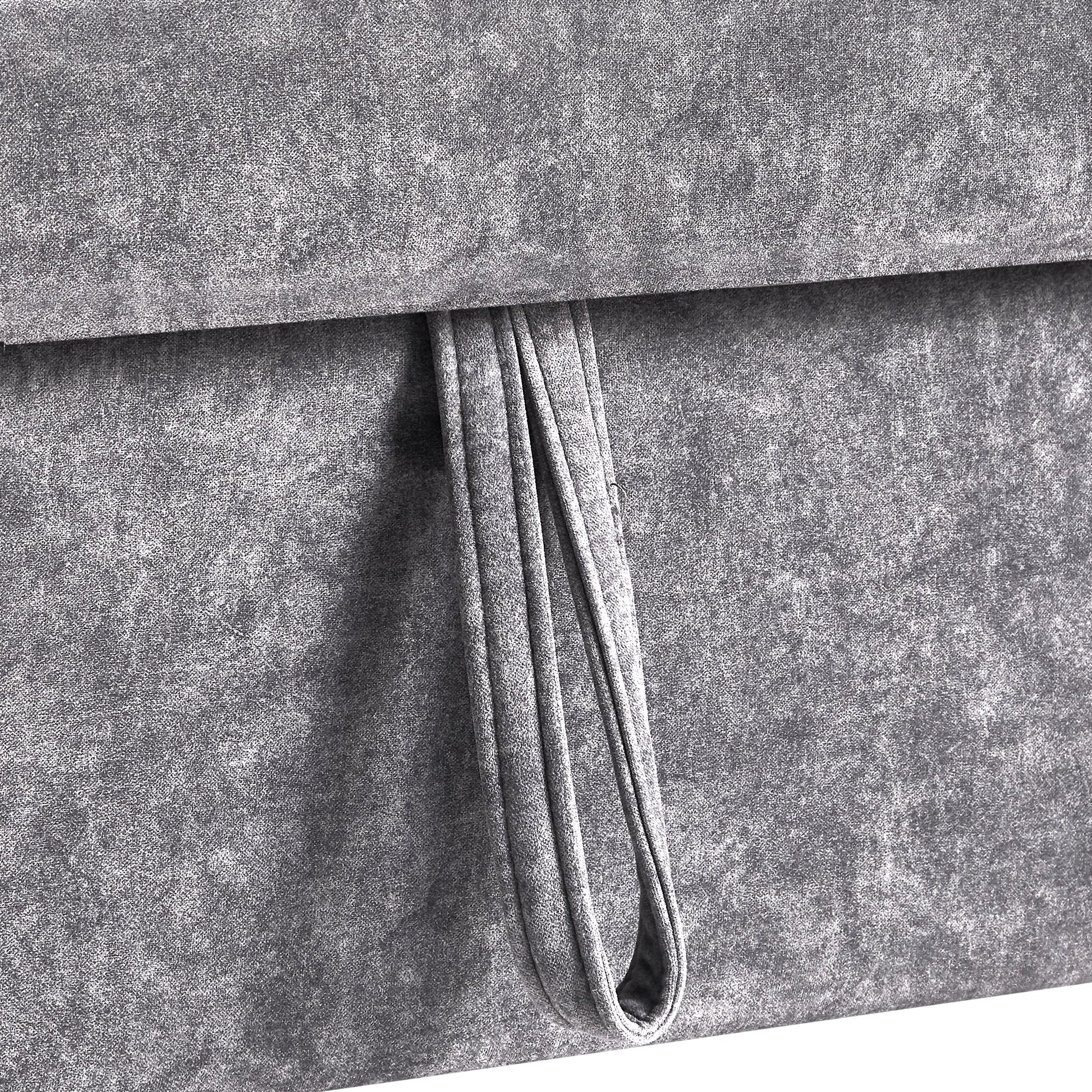 Closeup of textured grey fabric with a folded loop detail for storage boxes