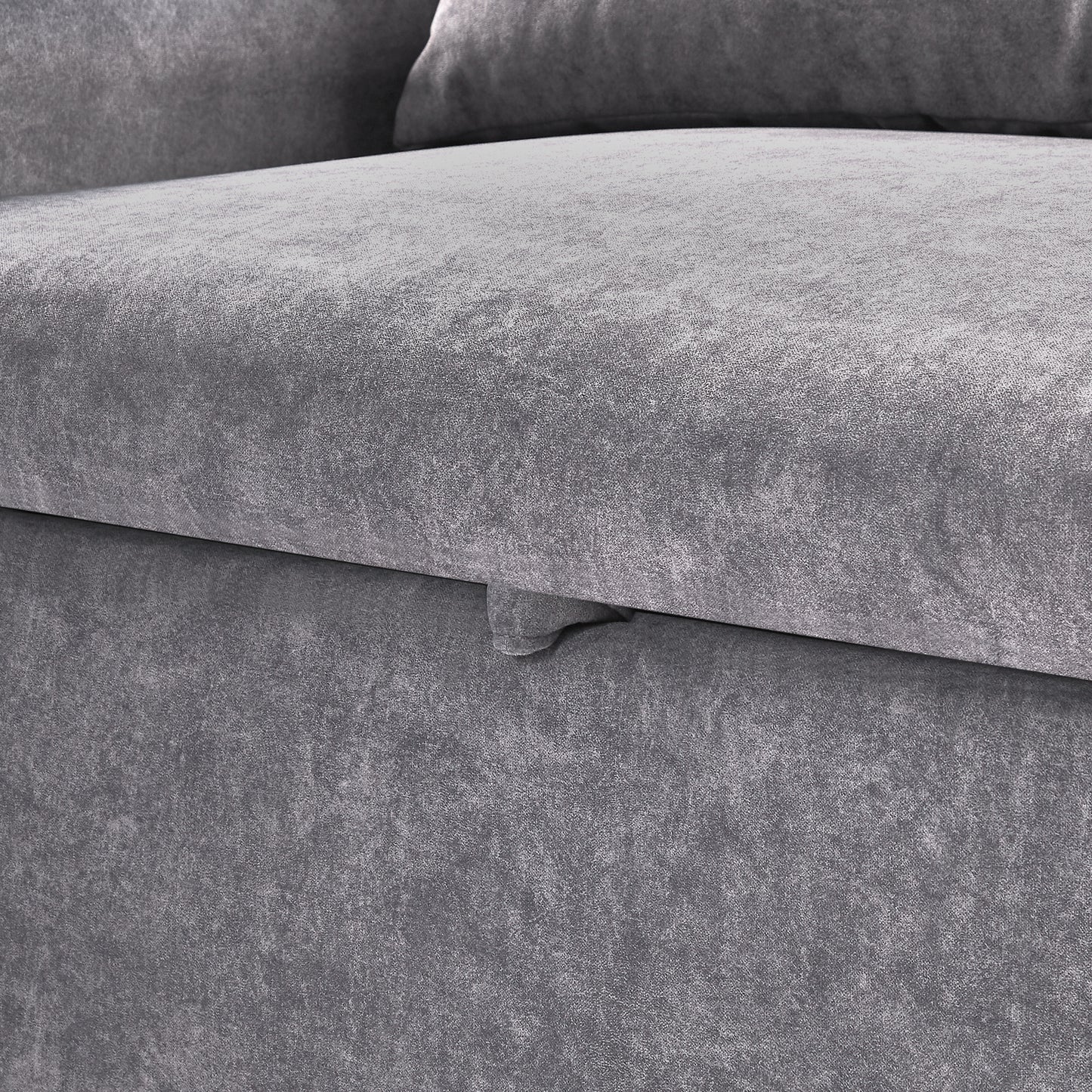 Closeup of grey textured fabric sofa with subtle sheen highlighting upholstery quality