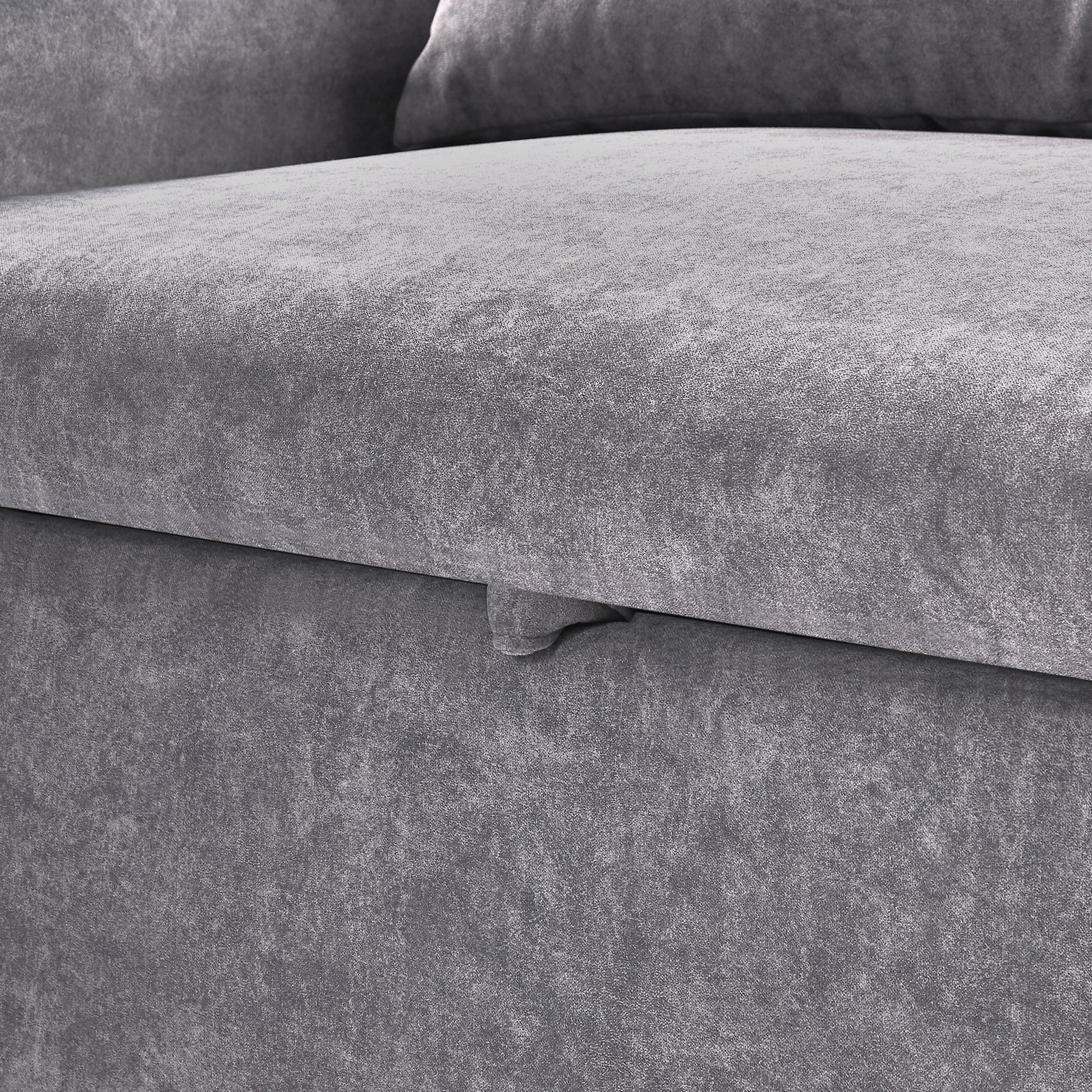 Closeup of grey textured fabric sofa with subtle sheen highlighting upholstery quality
