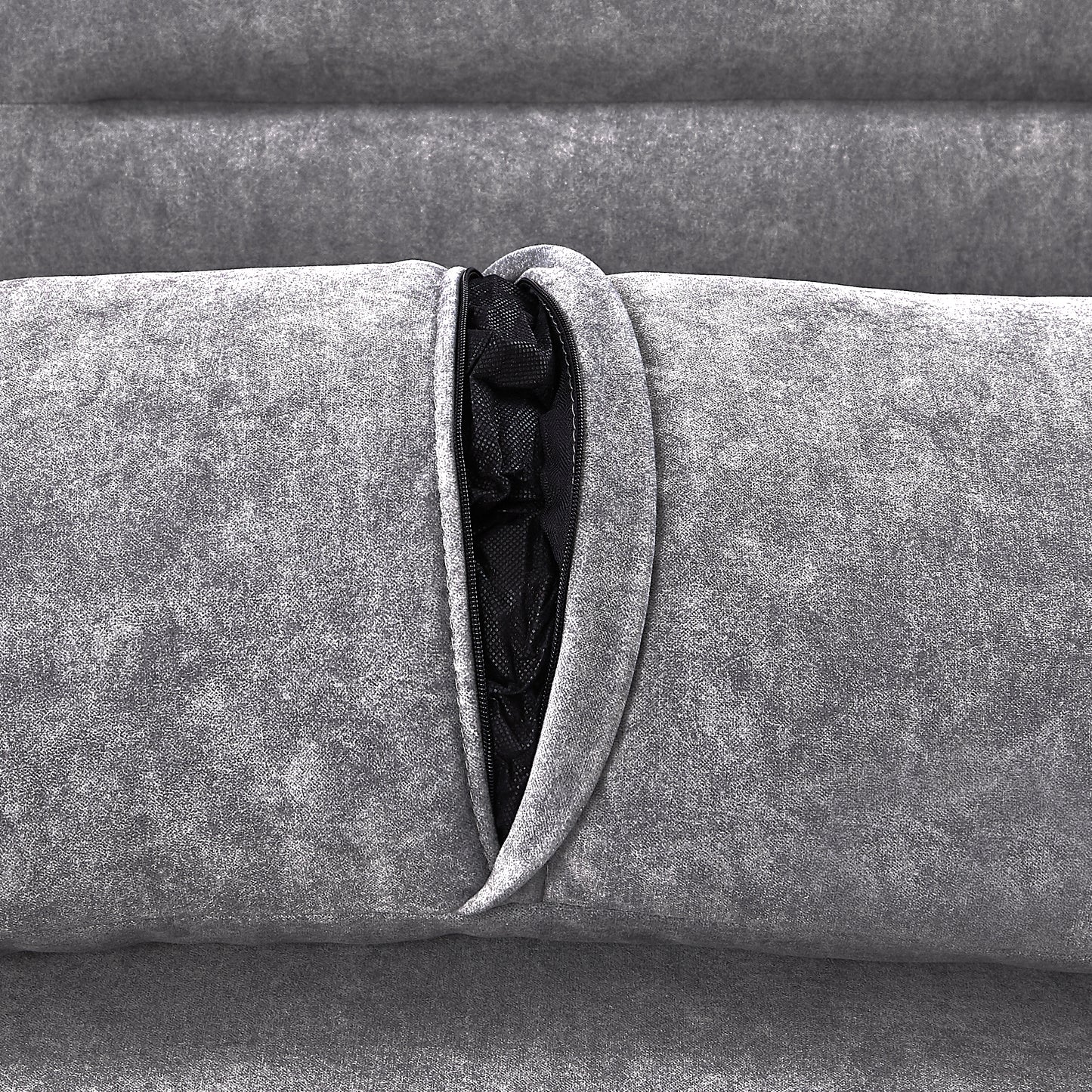 Closeup of grey textured fabric with a black zipper revealing mesh interior of a couch cushion