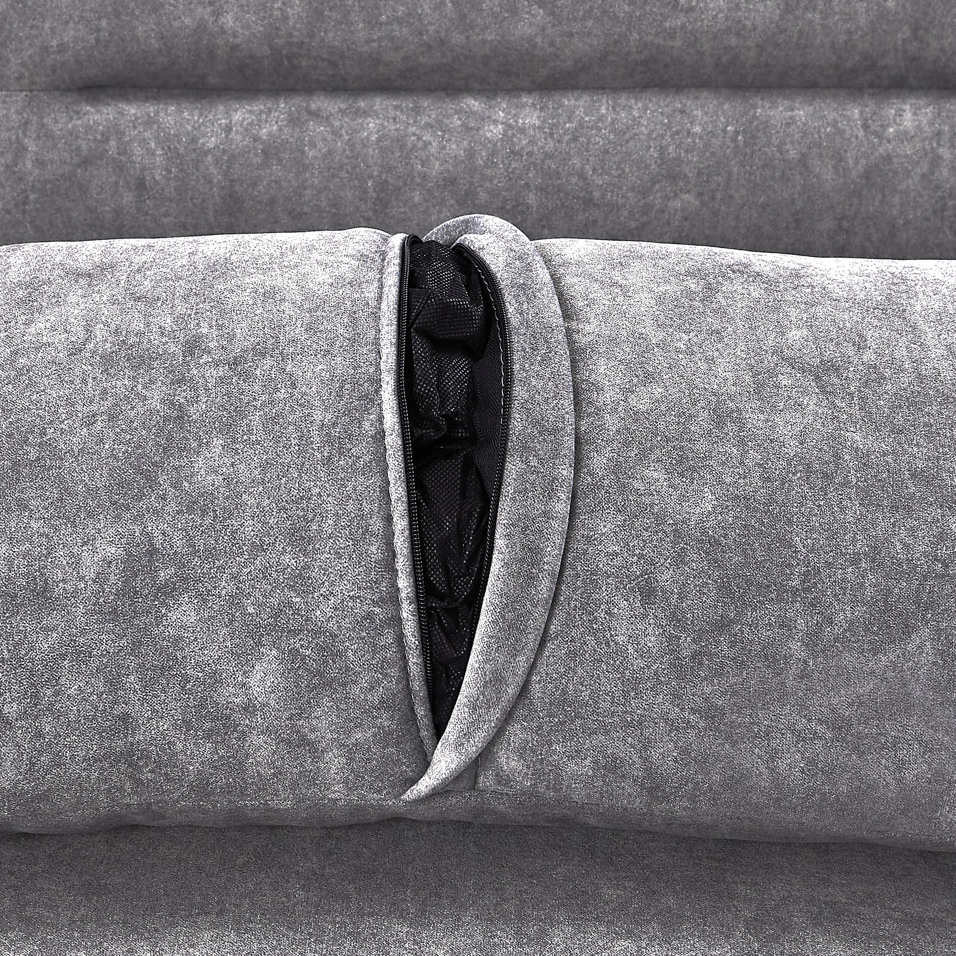 Closeup of grey textured fabric with a black zipper revealing mesh interior of a couch cushion