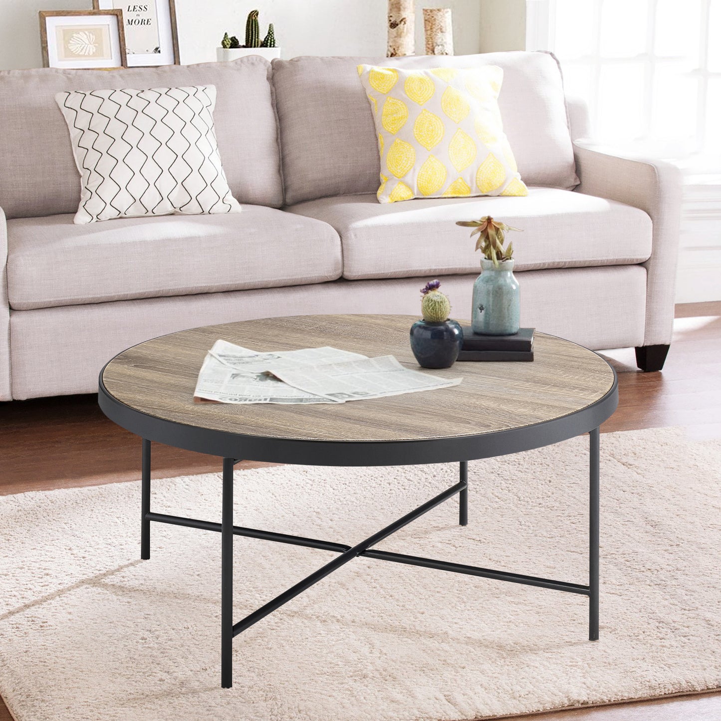 Round wood coffee table with black metal frame and legs