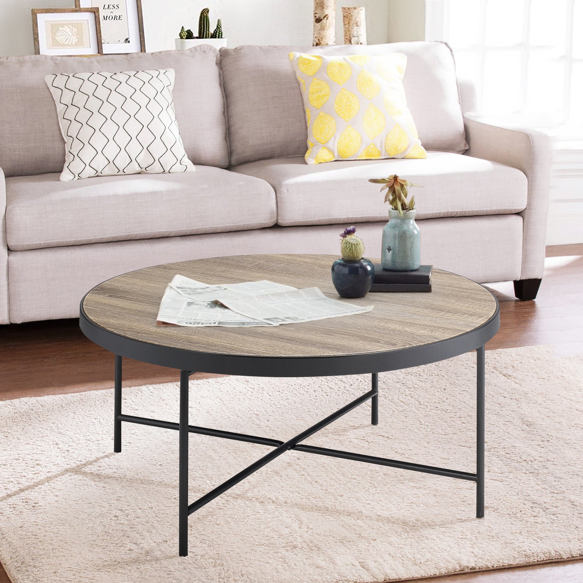 Round wood coffee table with black metal frame and legs