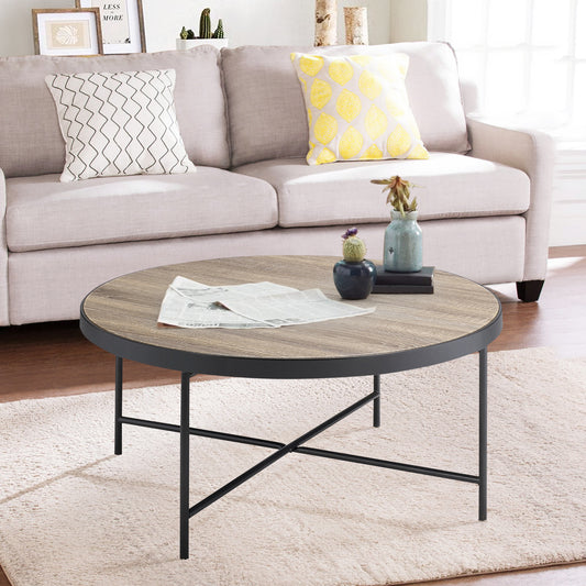 Round wood coffee table with black metal frame and legs