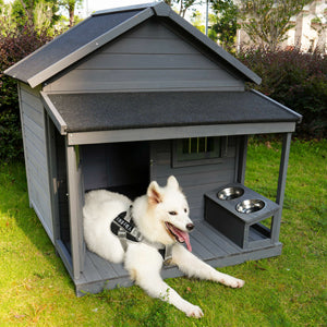 Gray wooden dog house with attached feeder station for outdoor pets
