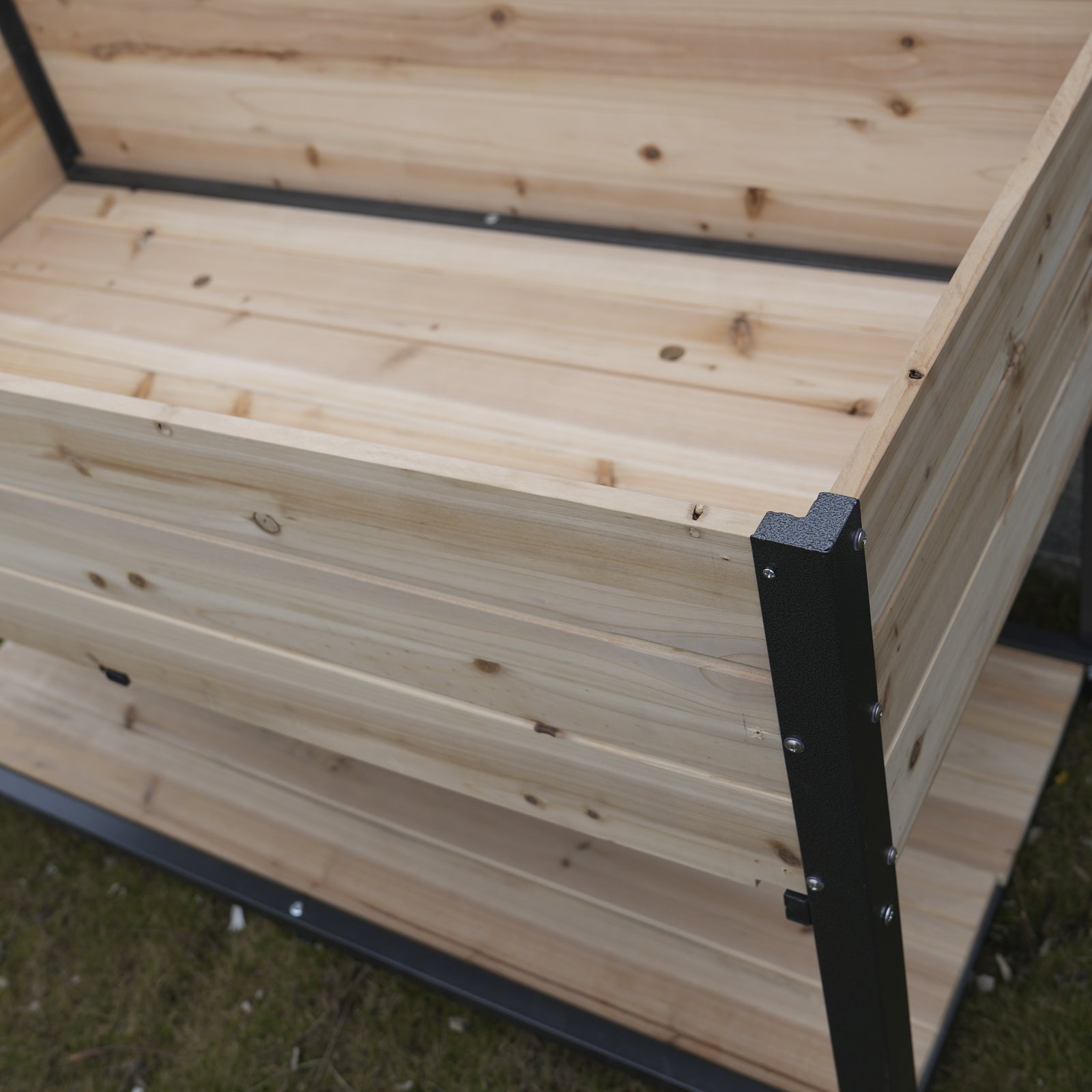 Natural wood raised garden bed with metal corner supports perfect for outdoor planting
