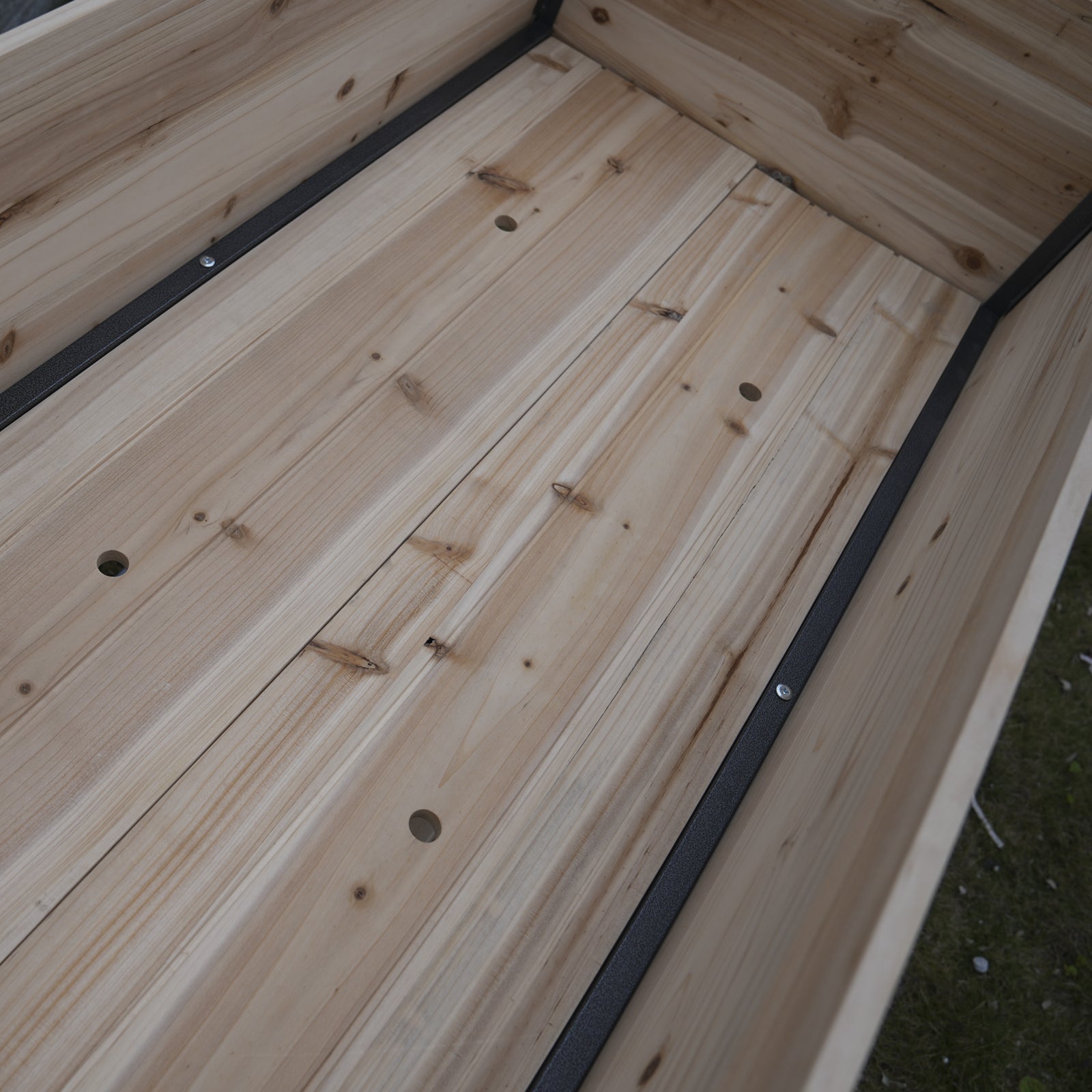 Wooden raised garden bed with slatted floor and metal corner supports