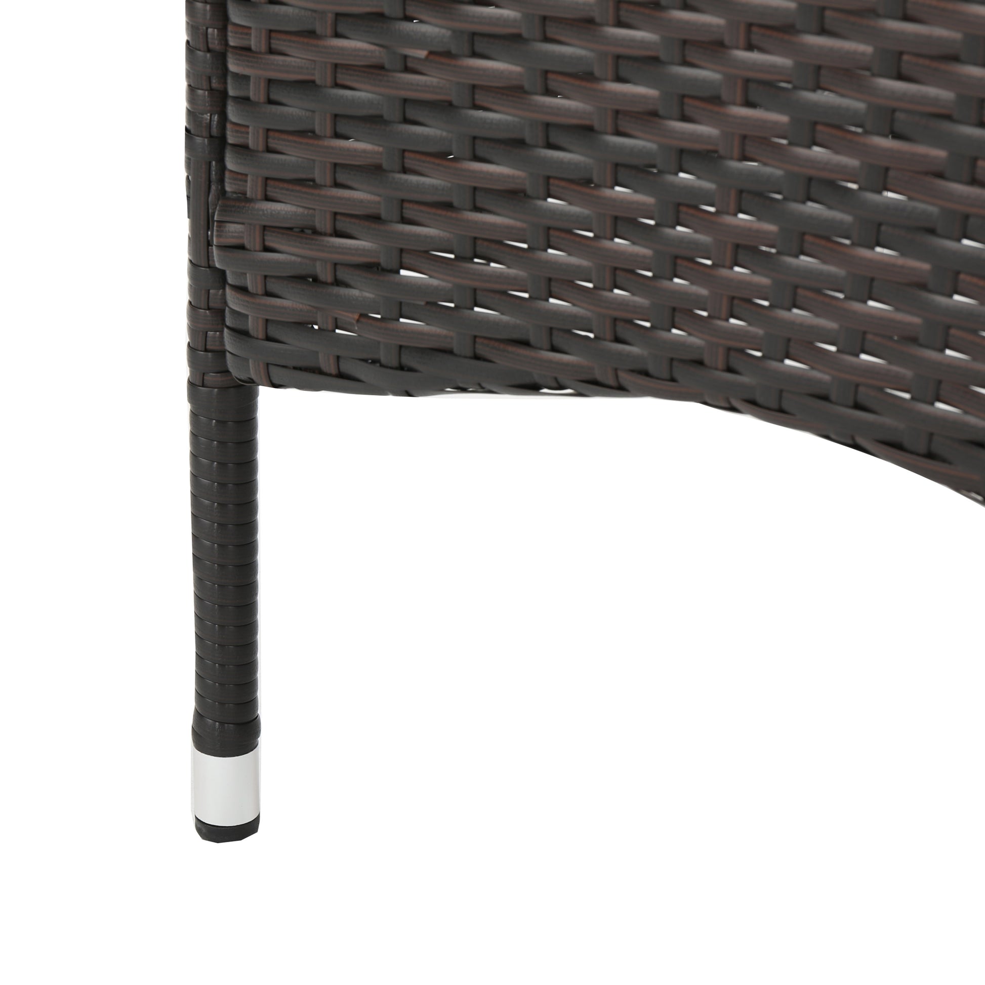 Dark brown rattan weave detail with silver foot caps on chair leg