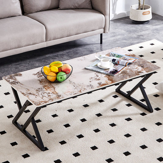 Marble pattern coffee table with black metal legs and a fruit bowl