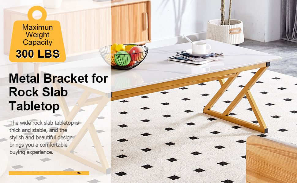 White rock slab coffee table with gold metal Xframe legs on a diamondpatterned rug