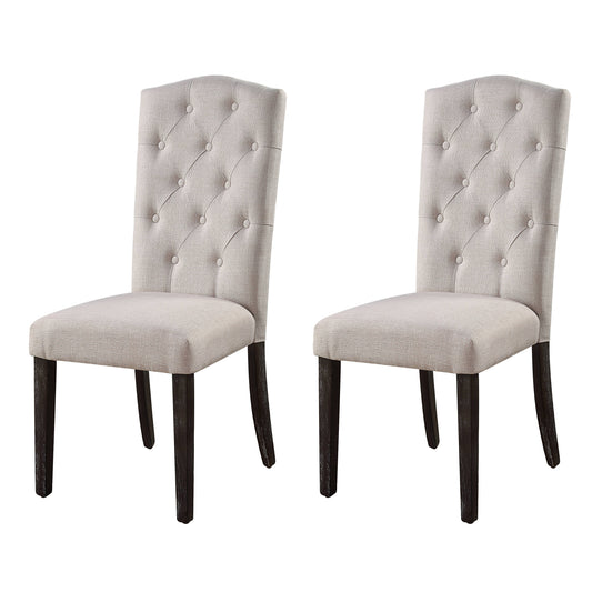 Two light grey fabric dining chairs with tufted backs and dark wood legs