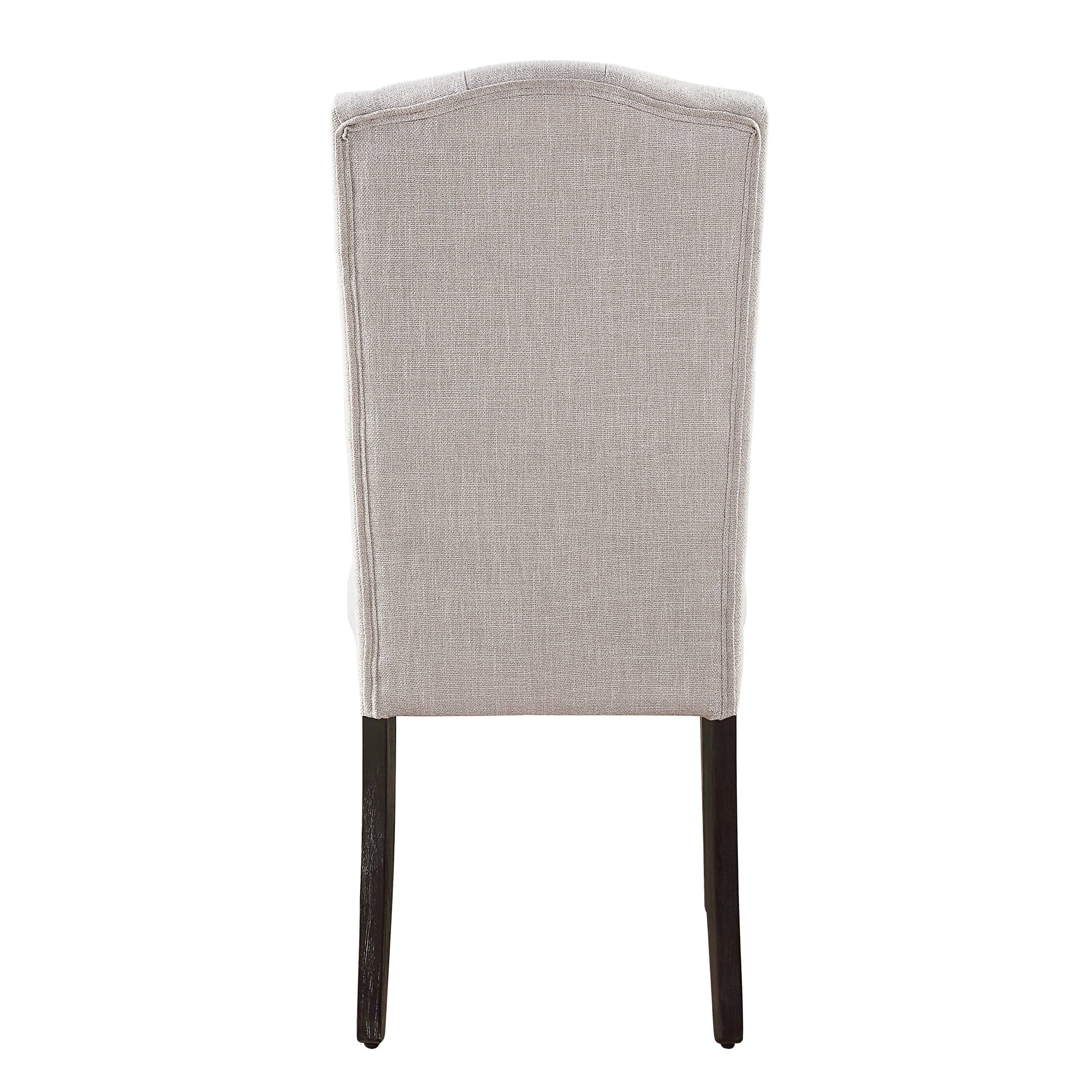 Tufted beige linen dining chair with dark wood legs seen from the back