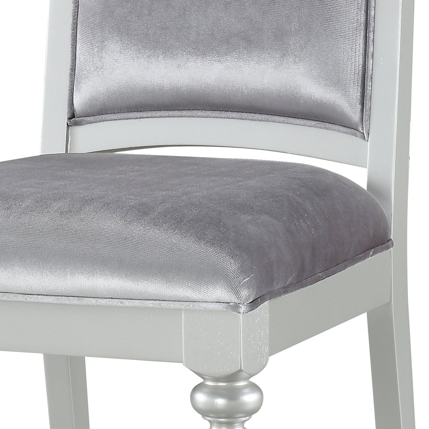 Silver velvet upholstered dining chair with white wooden frame and ornate leg