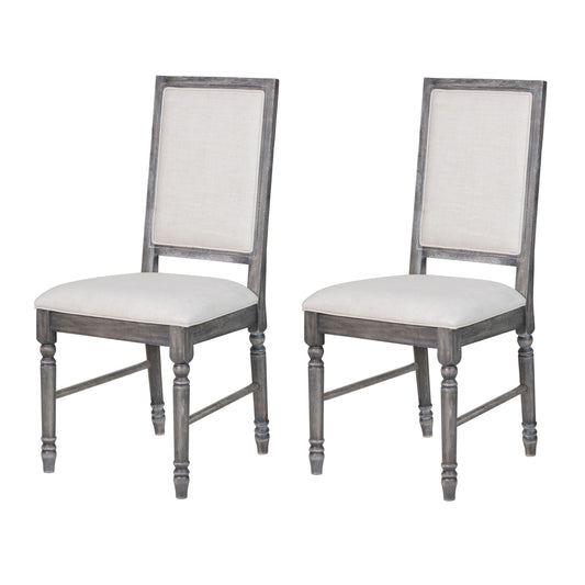 Two upholstered dining chairs with distressed gray wooden frames and light beige linen seats