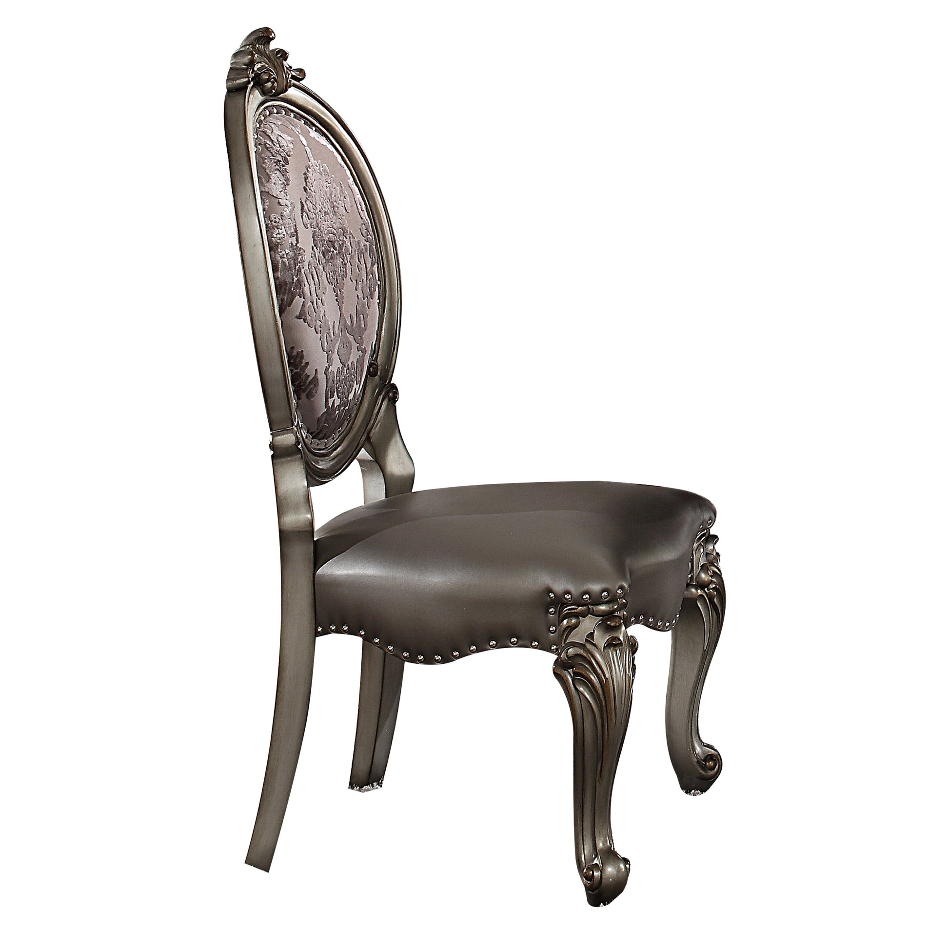 Antique dining chair with carved wooden legs and upholstered floral backrest
