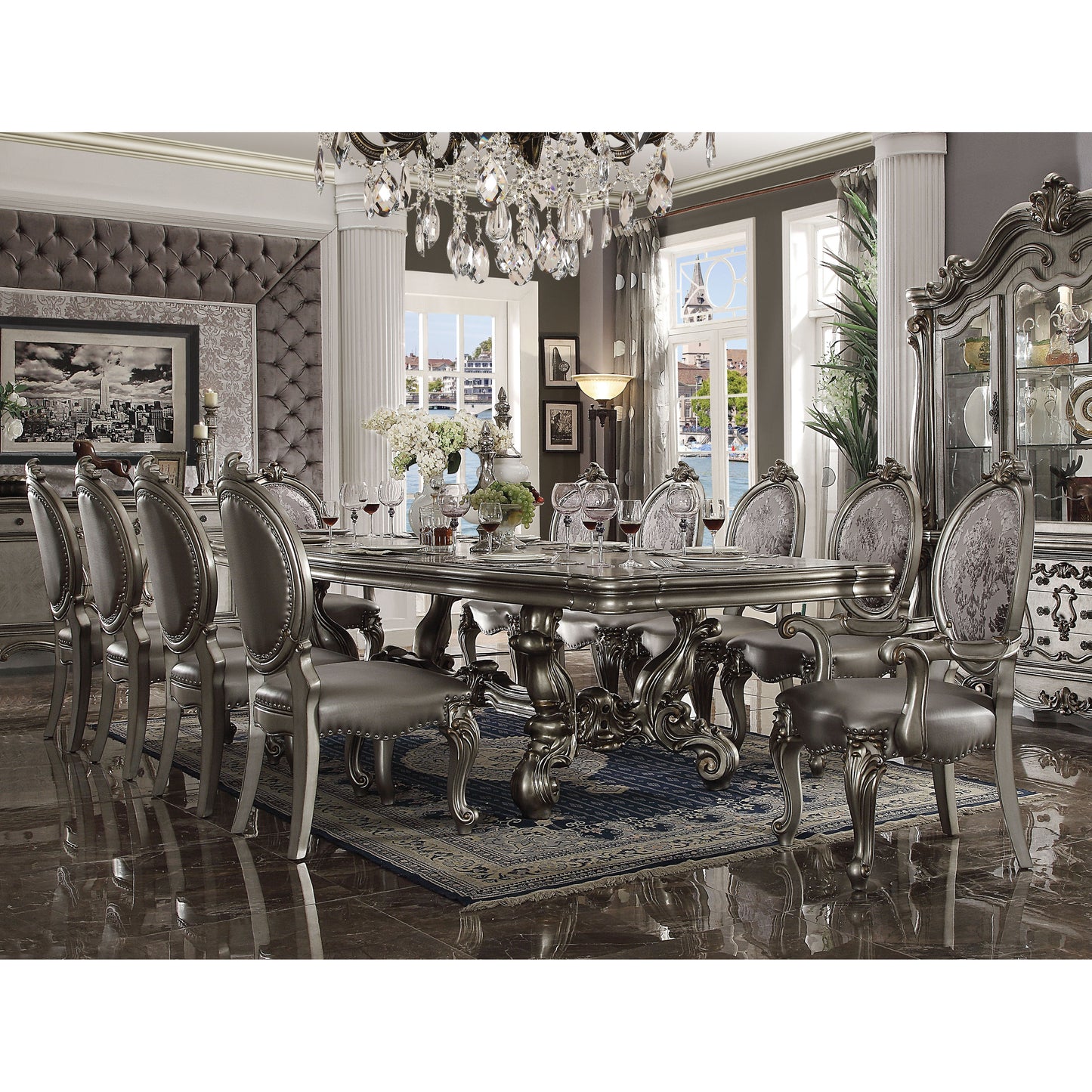 Elegant silver dining table set with ornate carved details and upholstered chairs perfect for formal dining