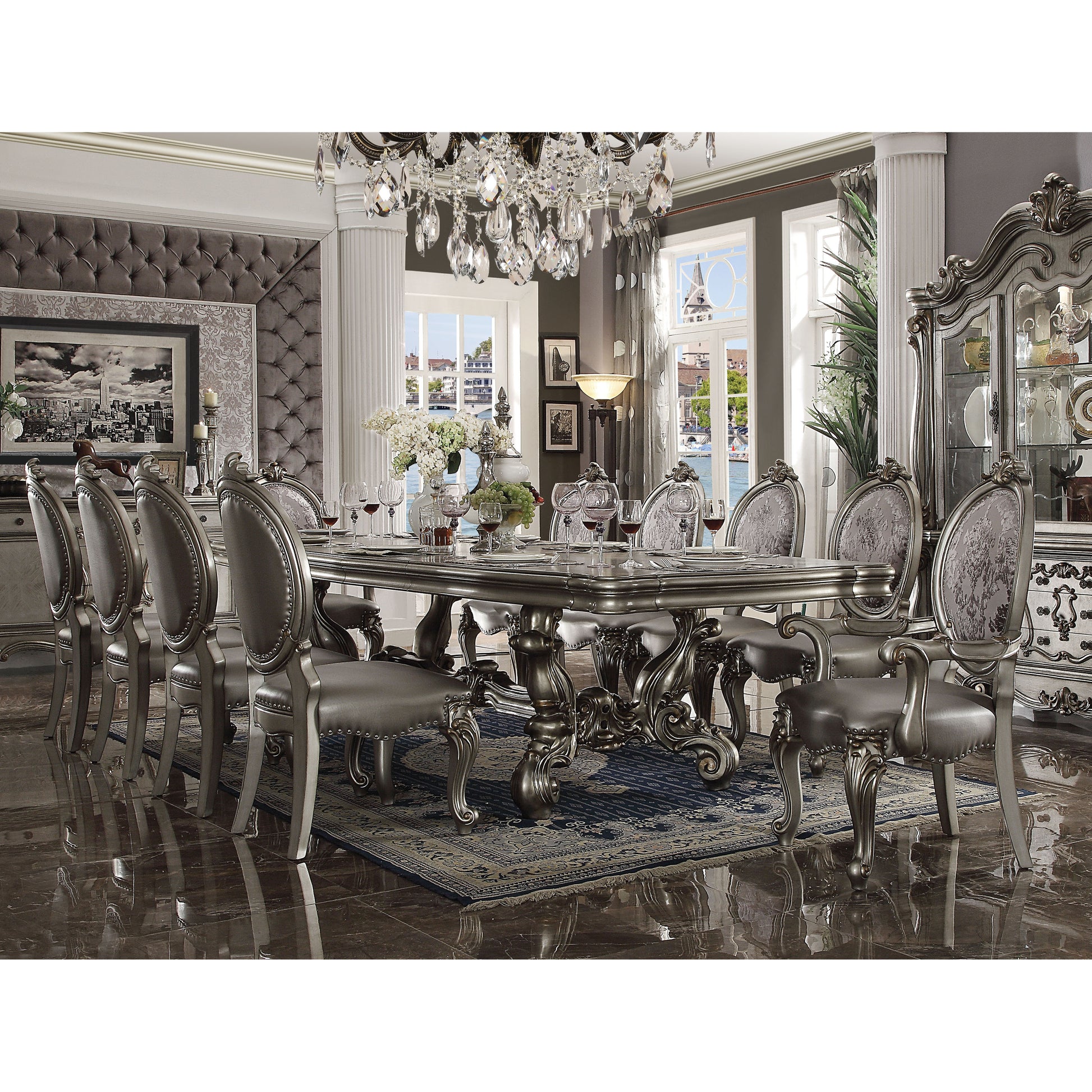 Elegant silver dining table set with ornate carved details and upholstered chairs perfect for formal dining
