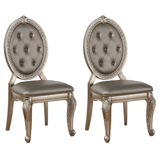 Two ornate silver dining chairs with tufted grey seats and carved legs