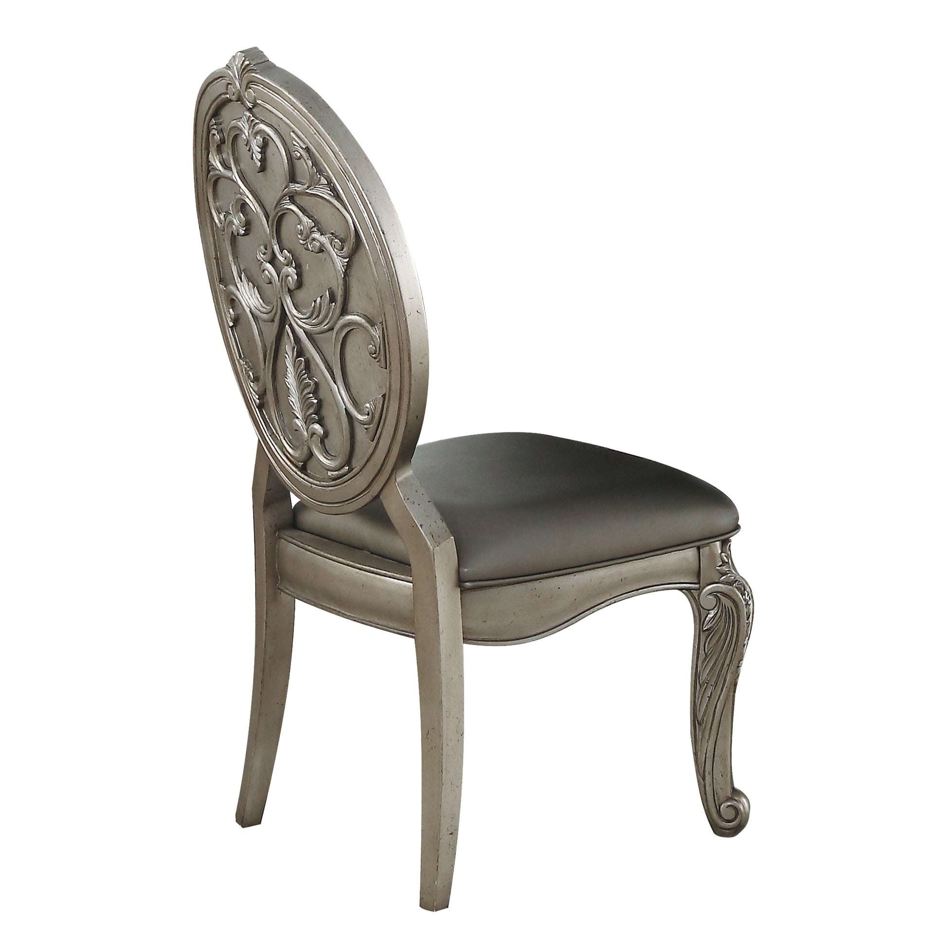Antique silver dining chair with ornate carved back and upholstered seat